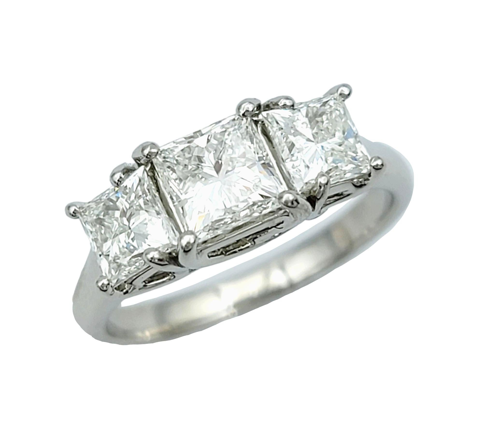 Ring Size: 5.5

This elegant three-stone princess cut diamond ring exudes timeless sophistication. Set in luxurious platinum, the ring boasts a classic yet refined design that captivates with its understated beauty.

The trio of pristine princess