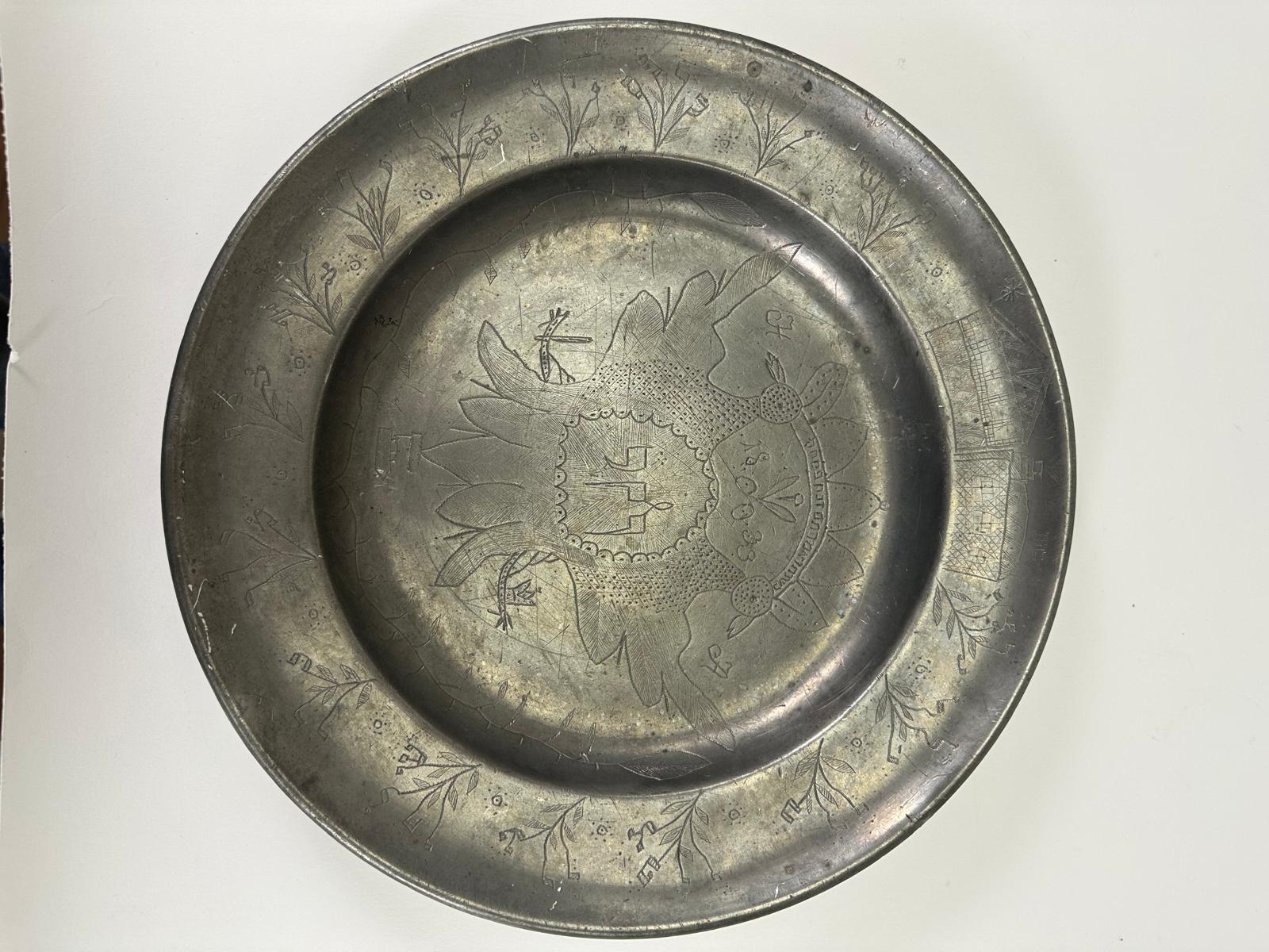 This pewter Passover plate, dated 1833, is a rare and exceptional example of 19th-century European Jewish folk art. Crafted in Germany, it features elaborate hand-engraved designs that blend religious symbolism with artistic motifs unique to Jewish
