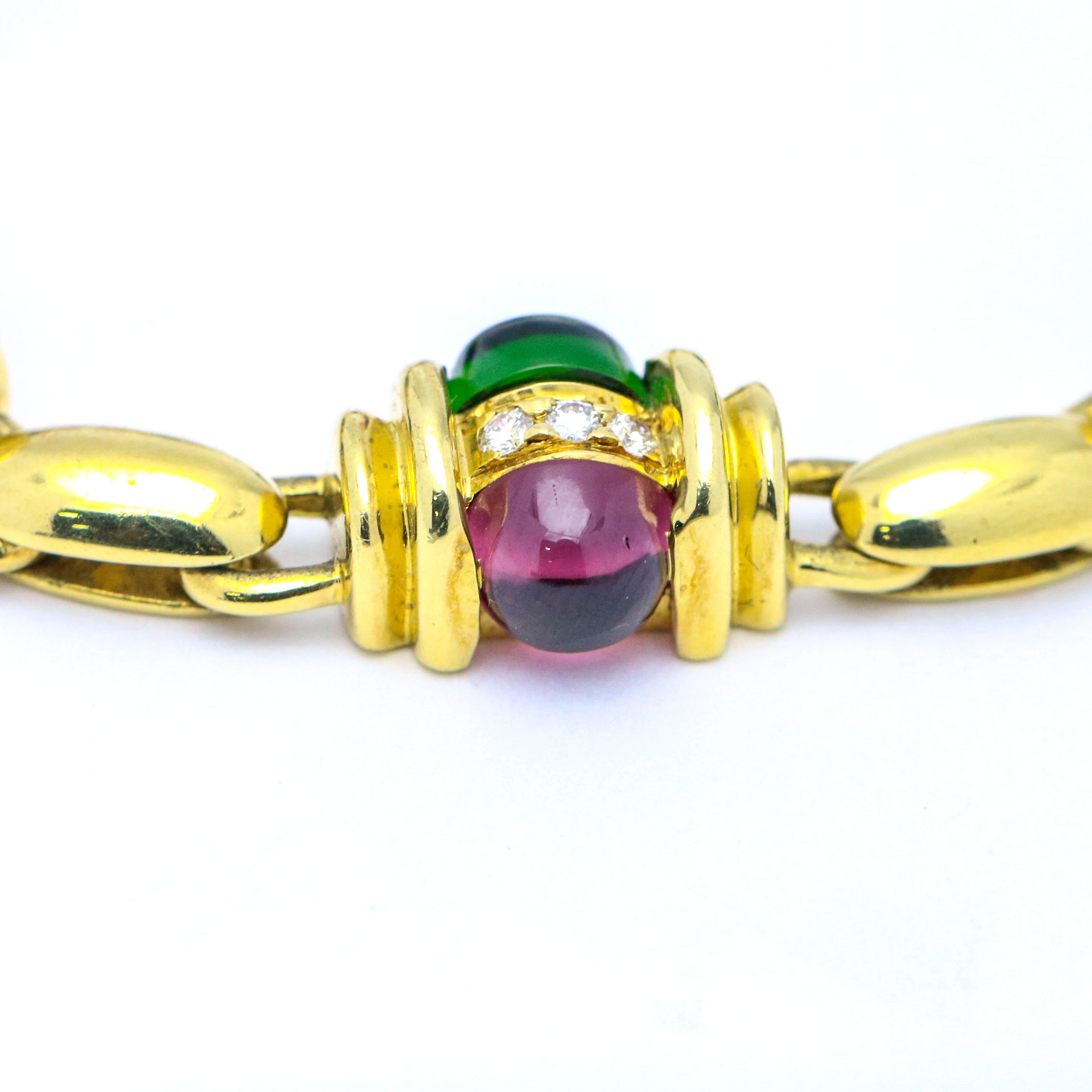 Custom Tourmaline and Diamond bracelet crafted in 18k yellow gold. The bracelet is set with 7 cabochon cut natural chrome tourmalines, 7 cabochon cut natural rubellite, and 21 full cut diamonds. The bracelet comes with an Appraisal by a GIA graduate