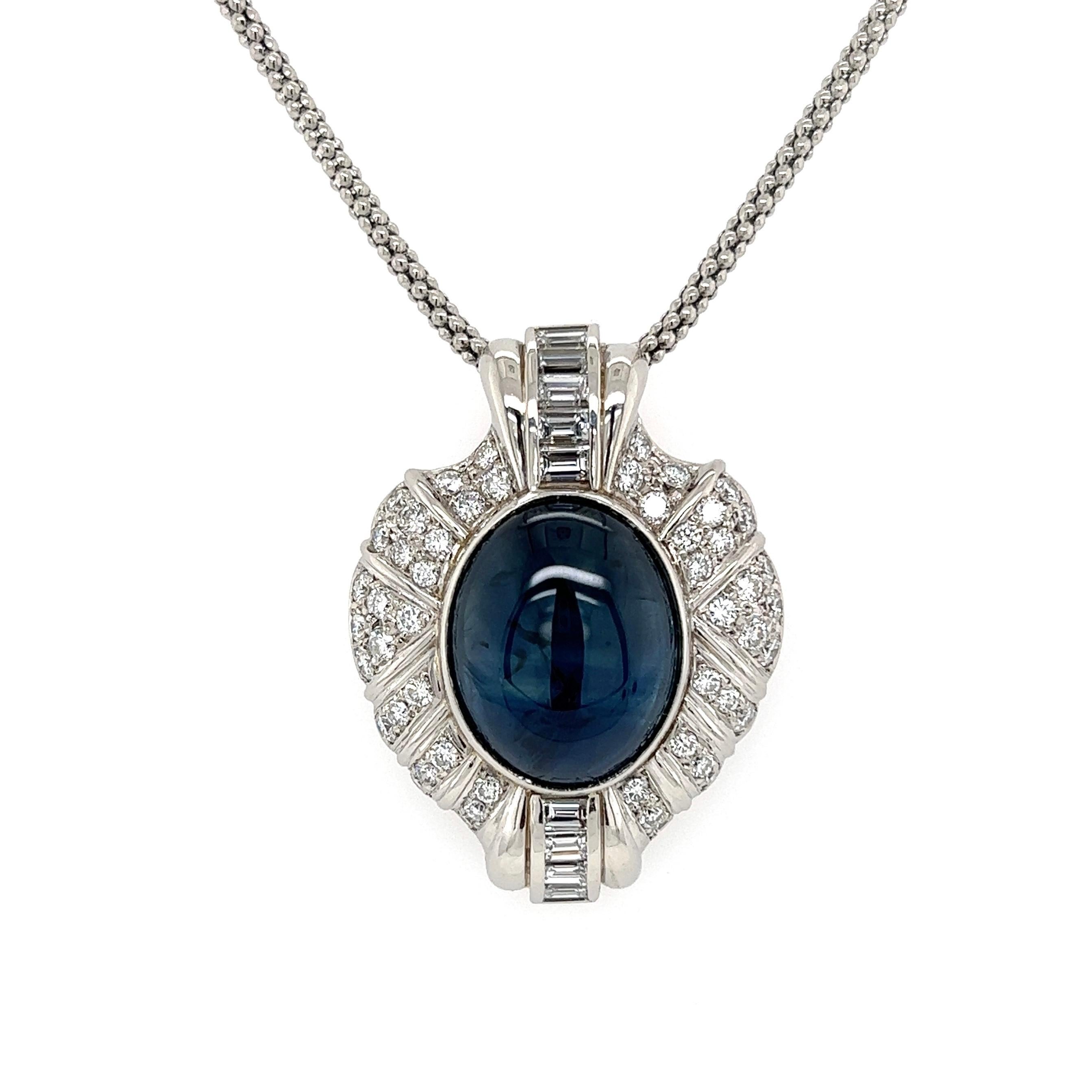 Simply Beautiful! Elegant and finely detailed Sapphire and Diamond Pendant Necklace, suspended from a 20” long Chain. Center of Pendant, securely Hand set with a Cabochon Sapphire, weighing approx. 18.35 Carats. GIA # 6214805116. Surrounded by