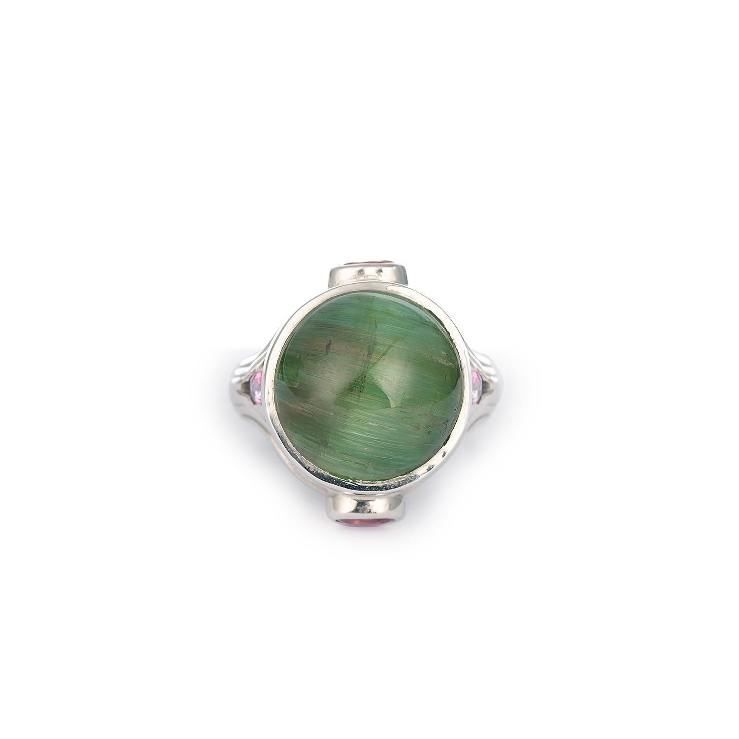 Original ring presenting in its middle a “cat’s eye” cabochon green Tourmaline.
The sides set with pink sapphires.

18K white gold, 750 / 1000th

Green tourmaline weight 18.37 carats

Pink sapphire weight: 1.20 carats

Size of the ring : 53 (FR) /