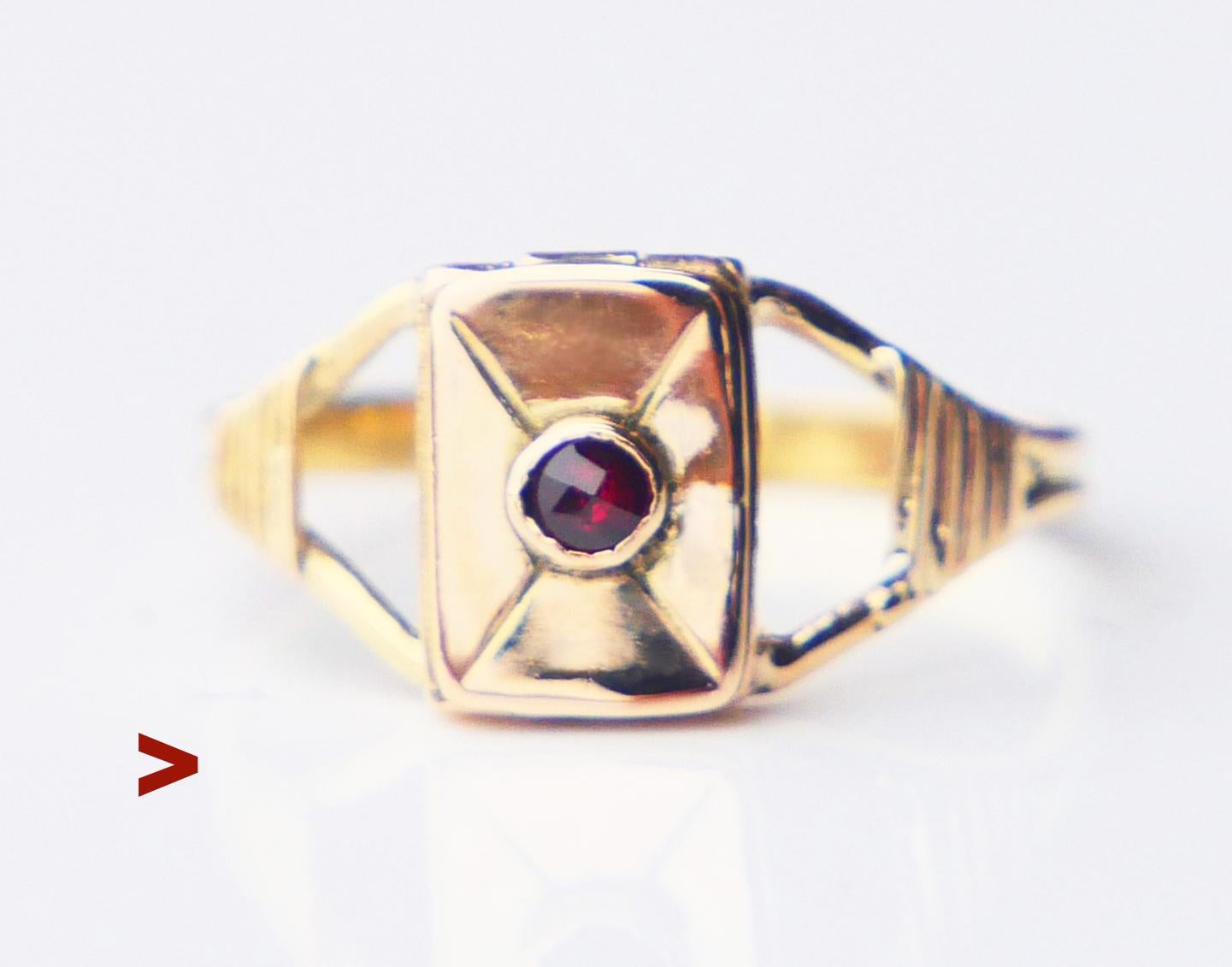 Old Poison Ring in solid 18K Yellow Gold with a hinged compartment on the crown. Hand- engraved Envelope pattern on top of the crown decorated with a bezel set rose cut Garnet stone Ø 2 mm .

It shuts pretty tightly with a click  and can only be
