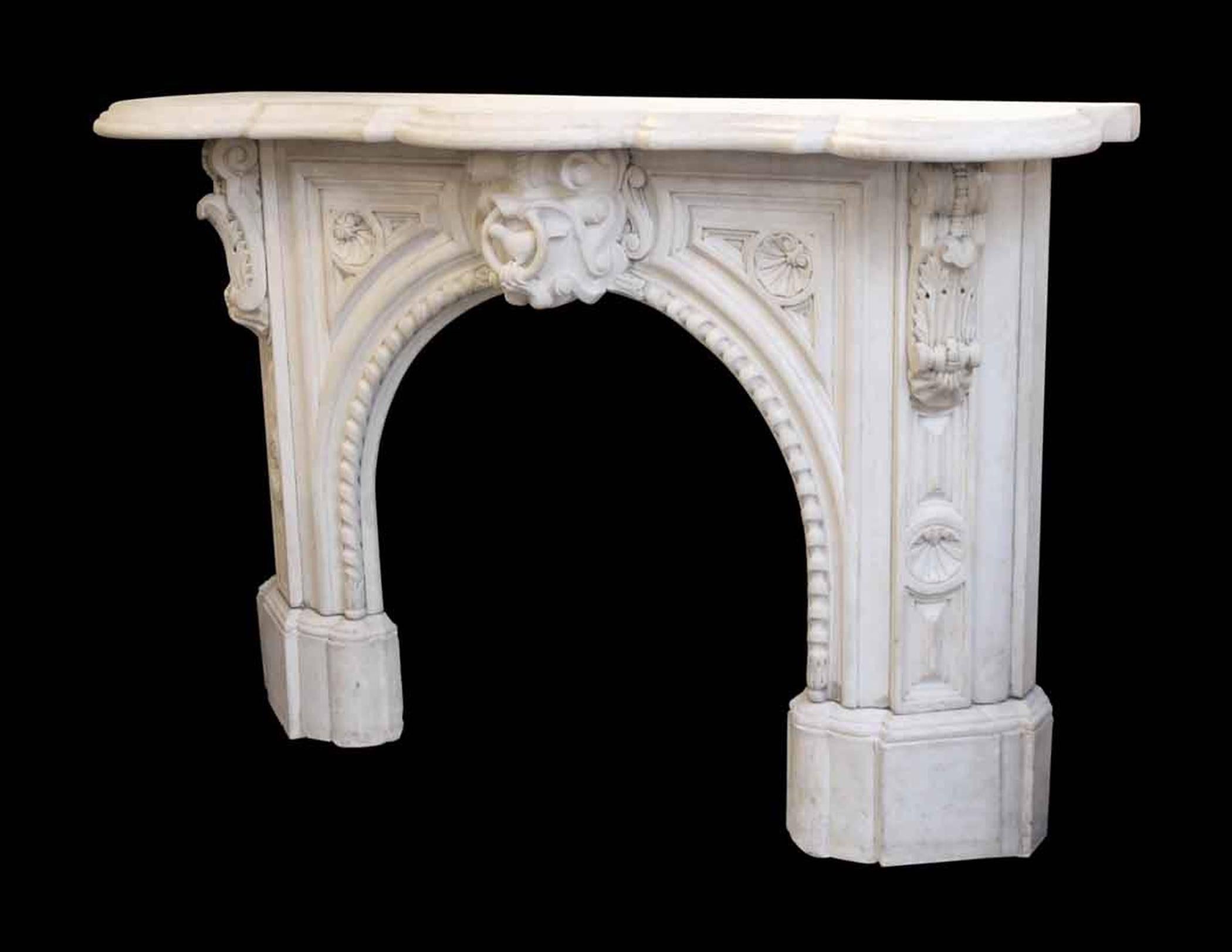 Victorian white statuary hand-carved arched marble mantel, circa 1838. Features a shell and bird motif with a beautiful beaded arched opening and leaf scrolled corbels. The detail on the bird's beak needs repair. This can be seen at our 5 East 16th
