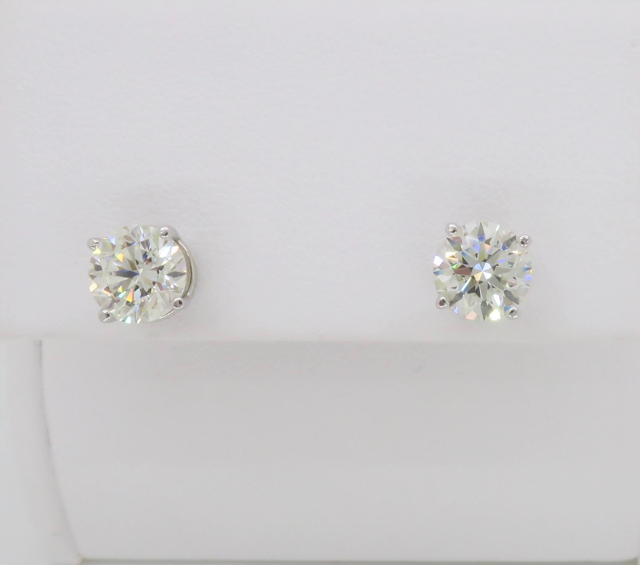 Stunning diamond stud earrings set in 14k white gold baskets, totaling 1.83ctw. 

Total Diamond Carat Weight: 1.83CTW (.91ct & .92ct)
Diamond Cut: Round Brilliant Cut 
Diamond Color: J-K
Diamond Clarity: VS1-VS2
Metal: 14k White Gold
Stamped: