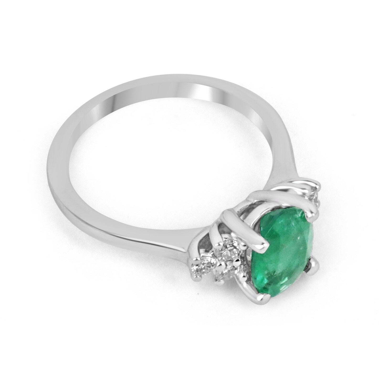 A stunning, classic oval emerald and round diamond engagement/right-hand ring 14K. The center stone features a lovely 1.53-carat, natural oval cut emerald that showcases excellent shine and a rare medium dark green color. Accenting the precious