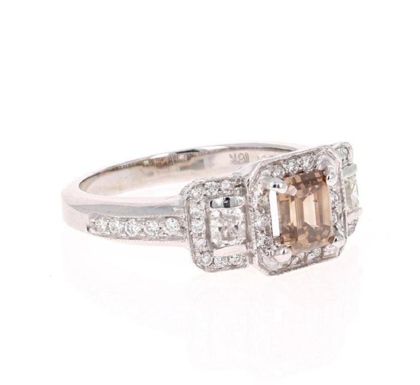 Gorgeous Champagne Diamond Three Stone Engagement Ring! 

Unique & One-of-a-Kind! 

The Emerald Cut Champagne Diamond weighs 1.01 Carats and has 2 Cushion Cut Diamonds on each side that weigh 0.30 Carats. The Clarity and Color of the Diamonds are
