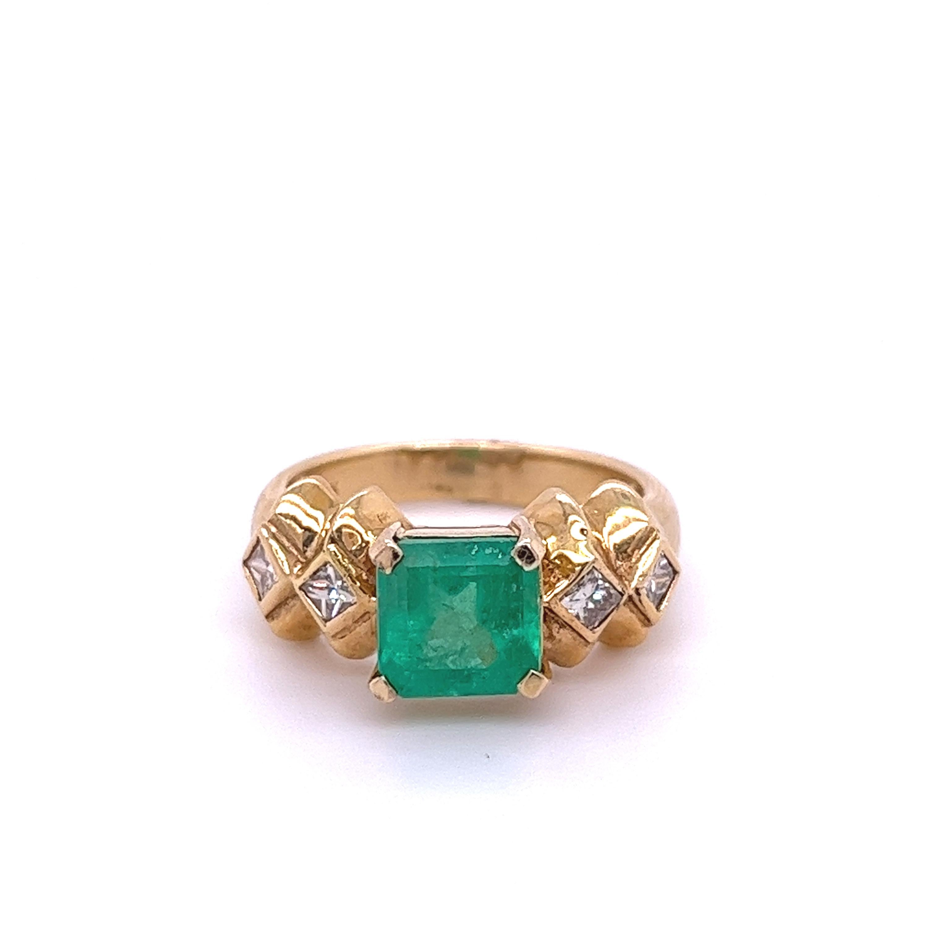 Emerald-cut Colombian Emerald mounted in 14k solid yellow gold ring set with princess-cut diamond accents. A superb quality Emerald with a vivid, bright green, color hue. This Emerald bears excellent luster, vibrance, and brilliance. 

14k solid