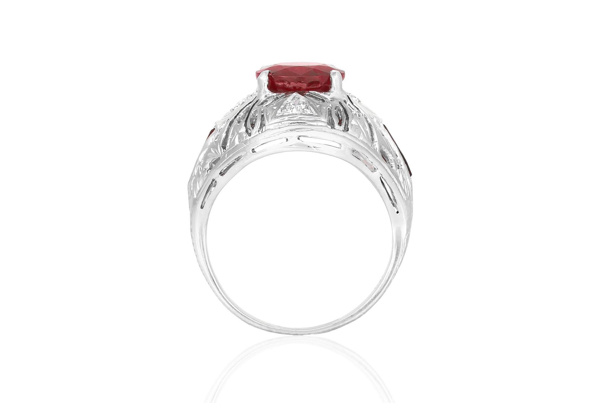 Estate ring, finely crafted in 18K white gold with filigree design. This ring features a cushion cut ruby at the center, weighing 1.84 carat. Accented with old mine cut diamonds on each side, weighing a total of 0.09 carats. Circa 1950's.



