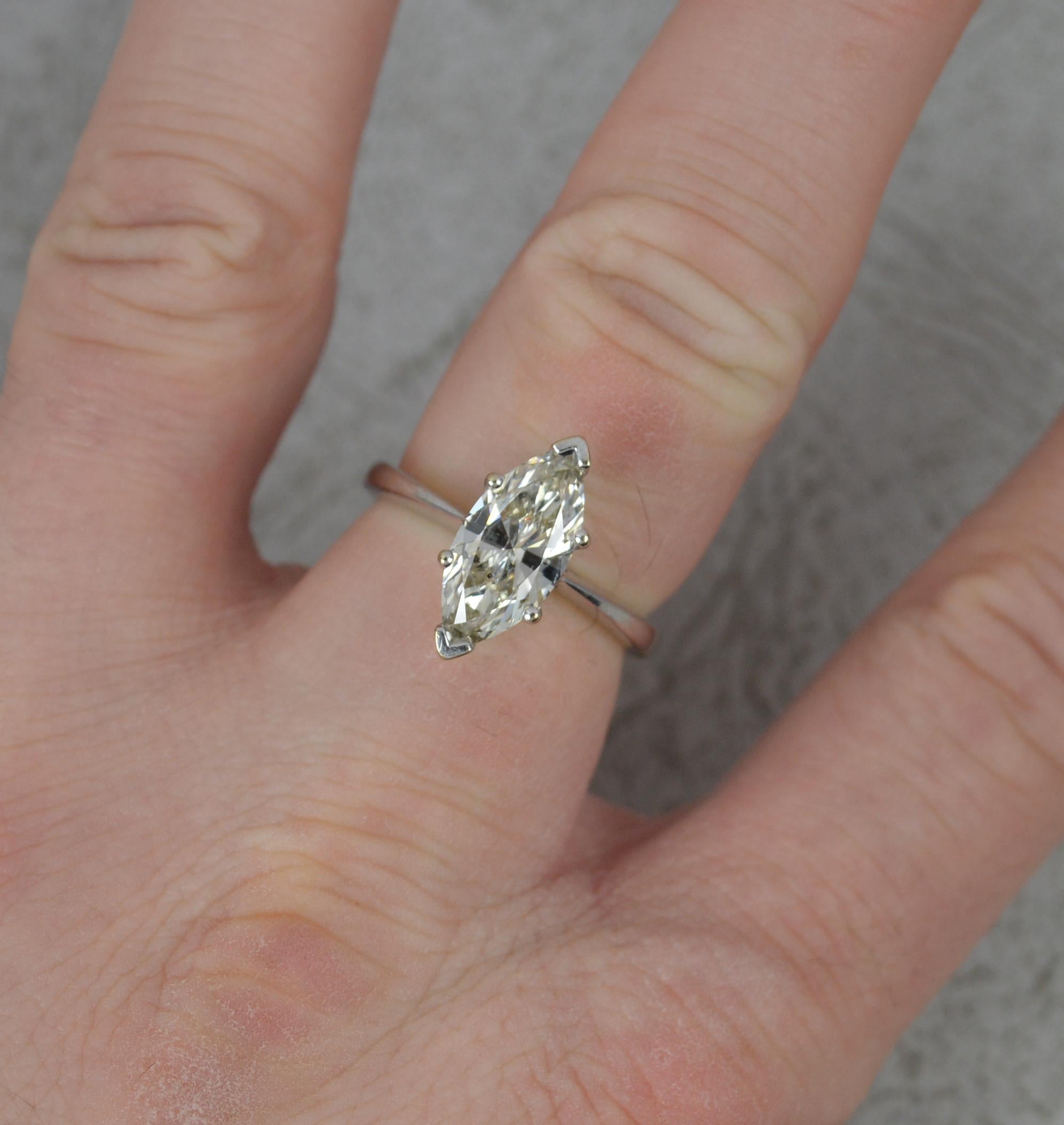 A single, natural diamond engagement ring.
Solid 18 carat white gold example with six claw setting.
Set with a marquise cut diamond complete with Birmingham Anchor Cert. 1.84 carats. 13mm x 6.3mm. i1 clarity, k colour. Overall a couple of black