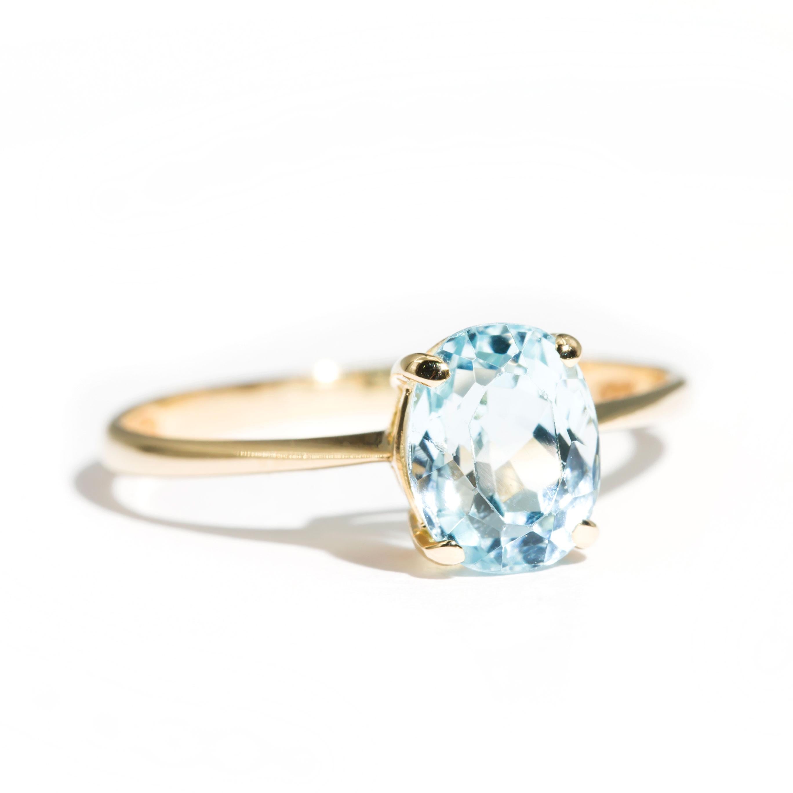Crafted in 14 carat yellow gold, this charming vintage solitaire ring features a lovely 1.84 carat bright light blue oval aquamarine. We have named this vintage splendour The Sally Ring. The Sally Ring is a darling ring that is embodies romance and
