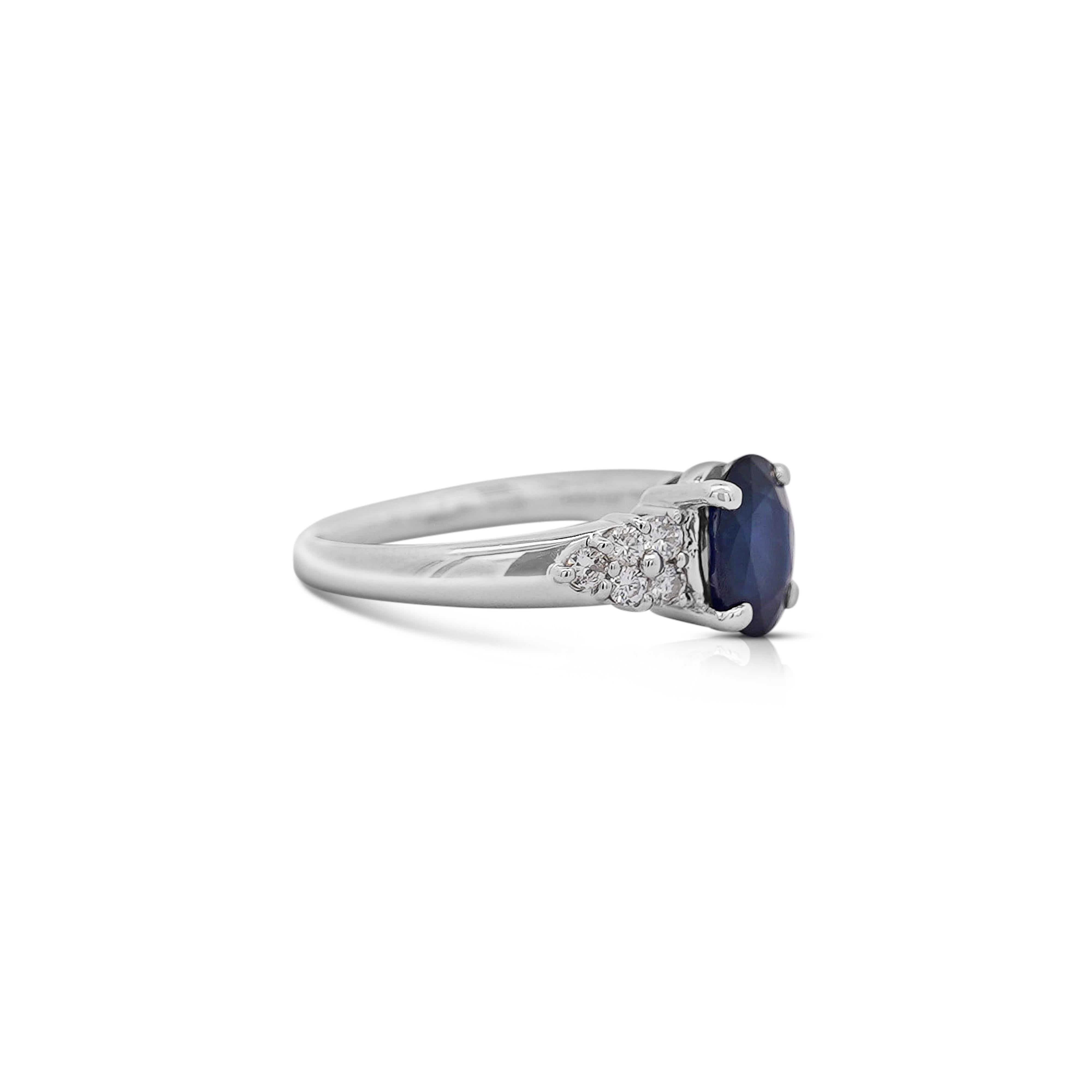 Natural 1.84 Carat Oval Cut Blue Sapphire and 0.27 CTTW Round Cut Pave Set Diamond Three Stone Illusion Style Ring 

Details: 
Item Type: Cocktail Ring
Metal: Platinum 900
Size: 6.5 (adjustable)
Weight: 5.45 Grams
 
Center Gemstone Details:
Type:
