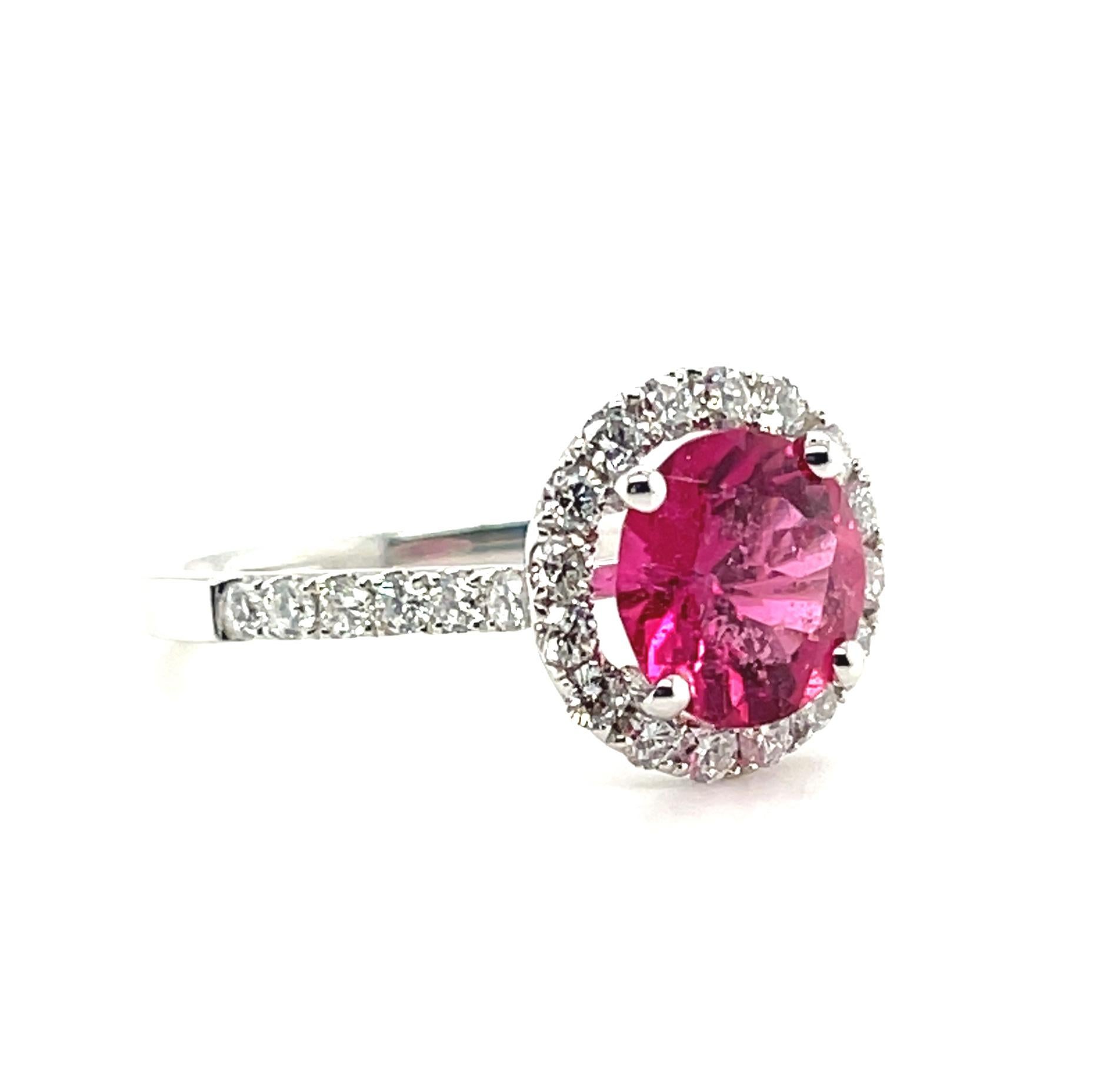 This beautifully designed ring features a lovely pink tourmaline gemstone surrounded by a halo of brilliant white diamonds! The pink tourmaline weighs 1.84 carats and has a gorgeous bubblegum pink color and exceptional brilliance. Sparkling diamonds