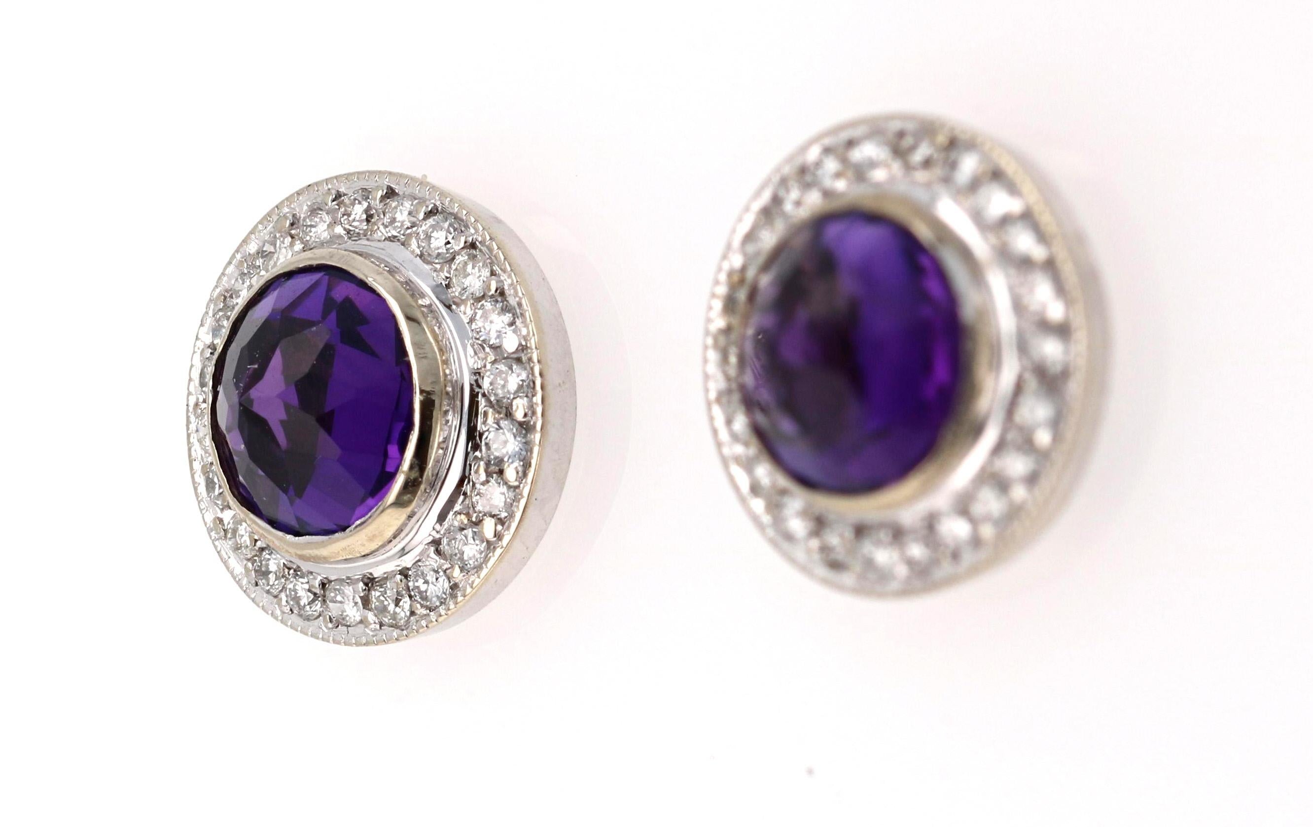 A cute and dainty pair of Amethyst Earrings accented with some Diamonds!

These cute studs have 2 Round Cut Amethyst stones that weigh 1.54 Carats and are surrounded by a beautiful halo of 46 Round Cut Diamonds that weigh 0.30 Carats. (Clarity: SI,