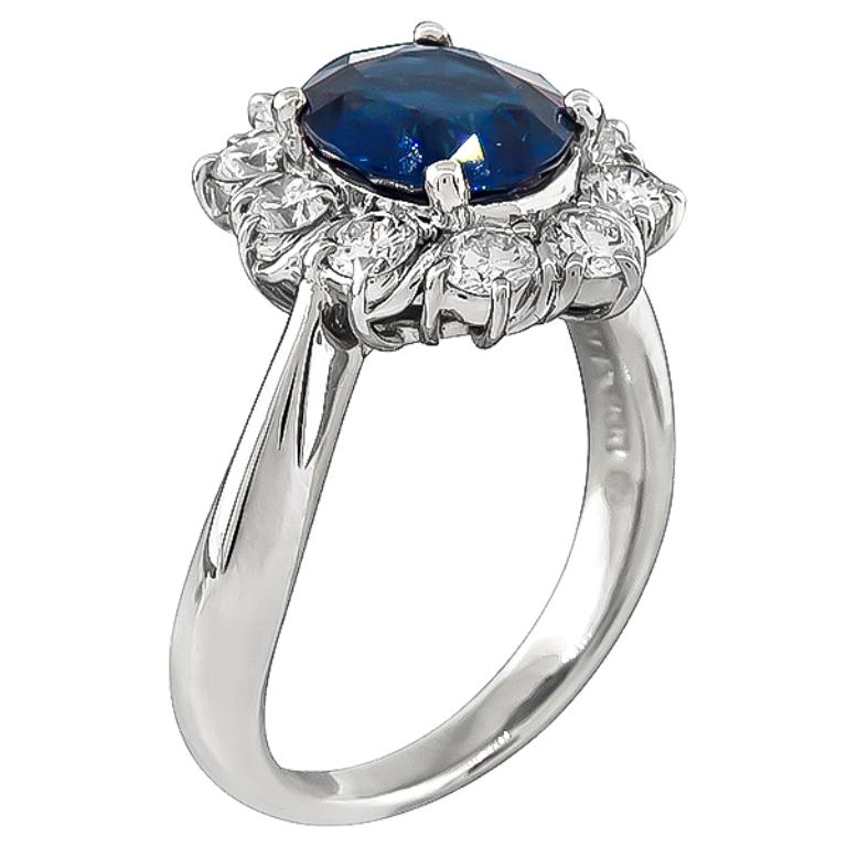This gorgeous platinum ring is centered with a high quality cushion cut sapphire that weighs 1.84ct. The center stone is accentuated by sparkling round cut diamonds that weigh 0.66ct. graded G color with VS clarity. The ring is stamped Pt900 1.840