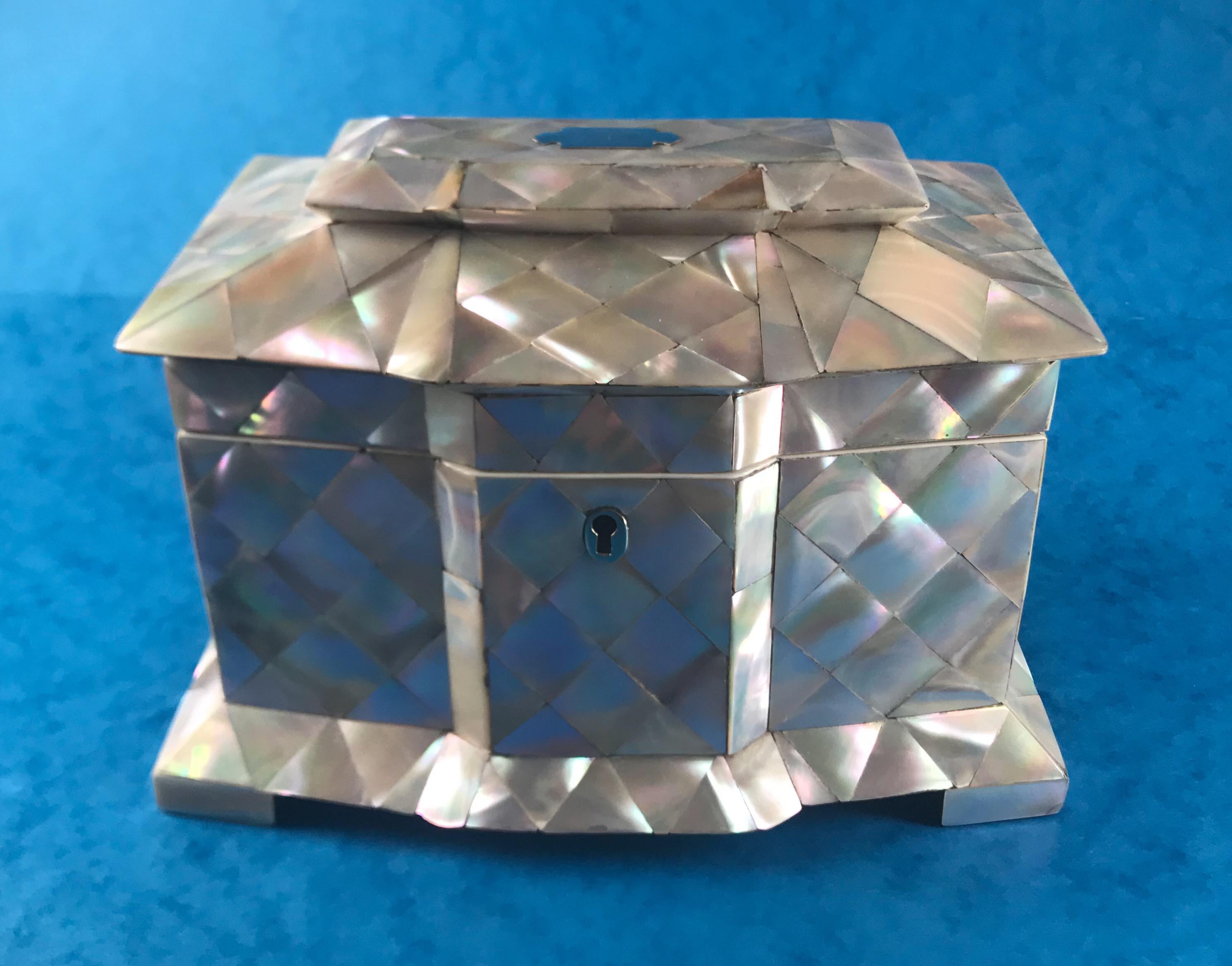 A 1840 Mother of pearl break front twin lidded tea caddy in superb condition, it has its original move velvet interior to the back of the lid and its original led lining interior. It has a working lock and key and a it measures 21 cm by 14 and