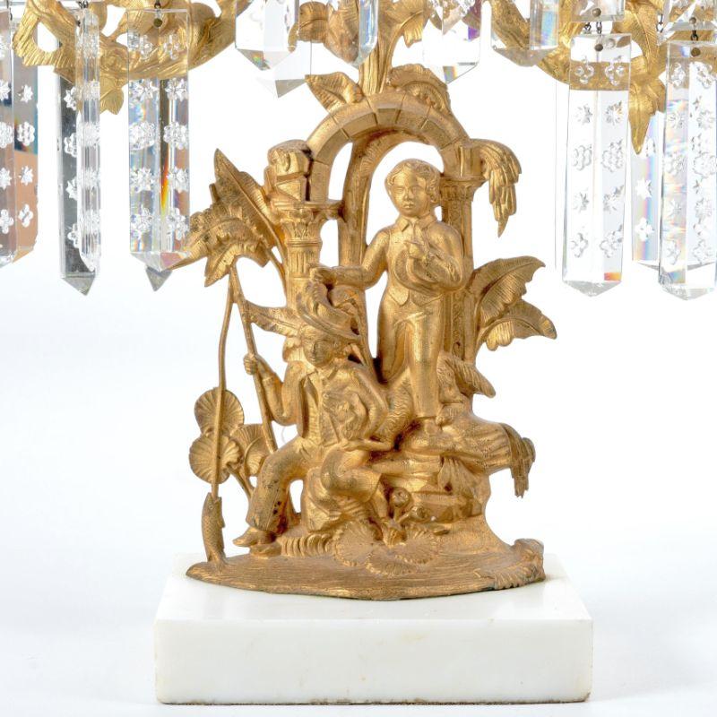 Cornelius & Co. three arm cast brass girandole candelabra mounted on a Vermont white marble base and fitted with lusters. The theme is of two boys fishing.
American, Philadelphia, circa 1840.