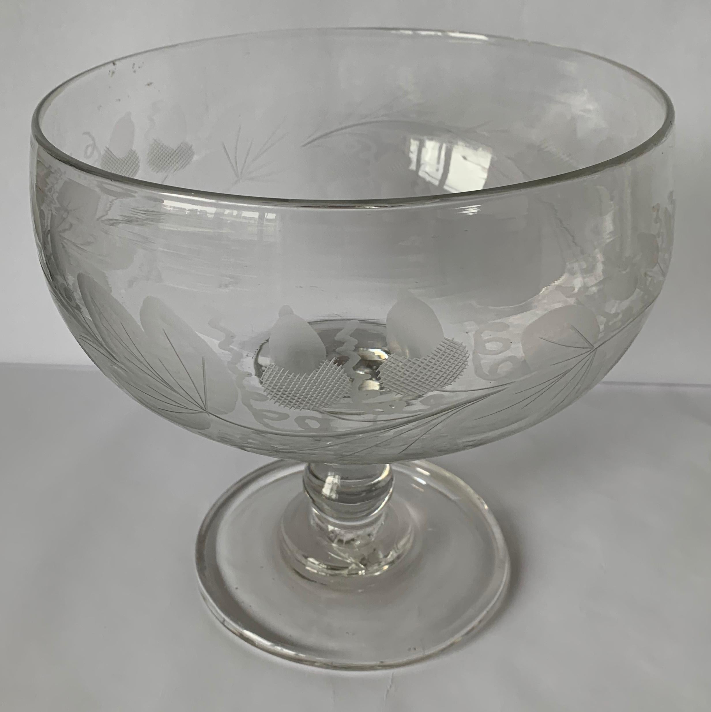 1840s antique American glass footed compote or bowl. Free form blown clear glass. All-over engraved acorn and oak leaf motif. No makers mark.
