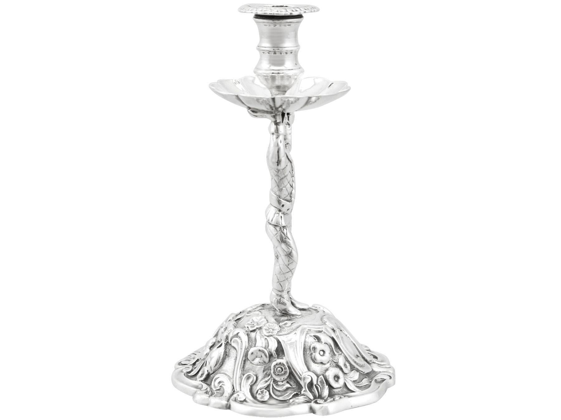 An exceptional, fine and impressive antique Victorian English cast sterling silver taperstick; an addition of our ornamental silverware collection.

This exceptional antique Victorian sterling silver taperstick has a circular rounded form with a