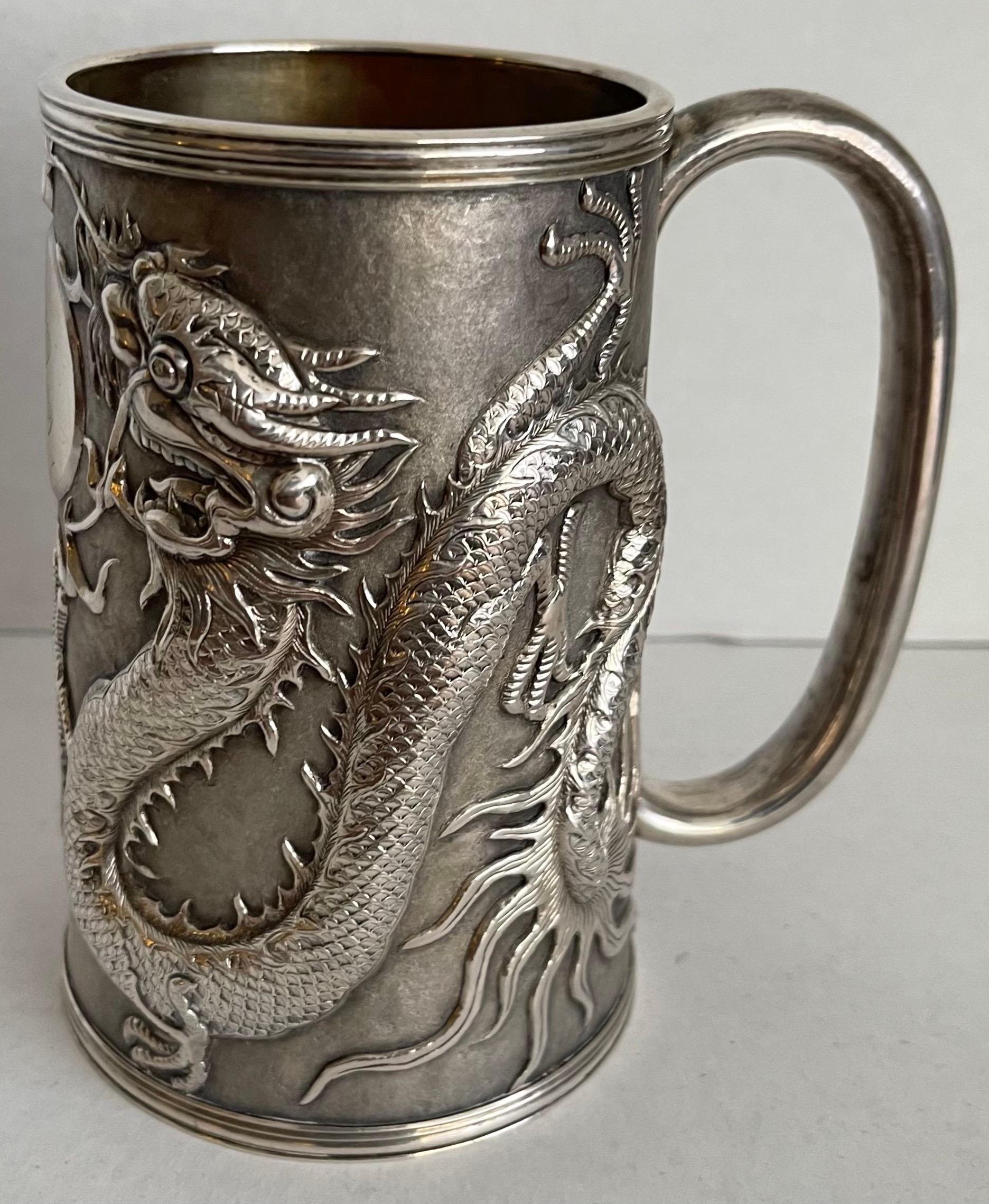 Chinese export 1840s silver dragon tankard. Featuring two bold well defined dragons with central pearl of wisdom design. Solid weighty construction. Center monogram. 
Makers mark on the underside GM (Gem Wo workshop).