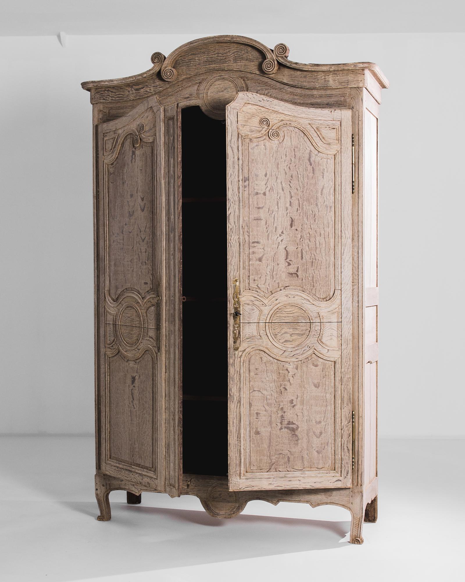 Stepping into the refined interiors of 19th-century France, this bleached oak armoire from the 1840s exudes the elegance and sophistication of the era. Crafted with exquisite attention to detail, this piece represents the epitome of French
