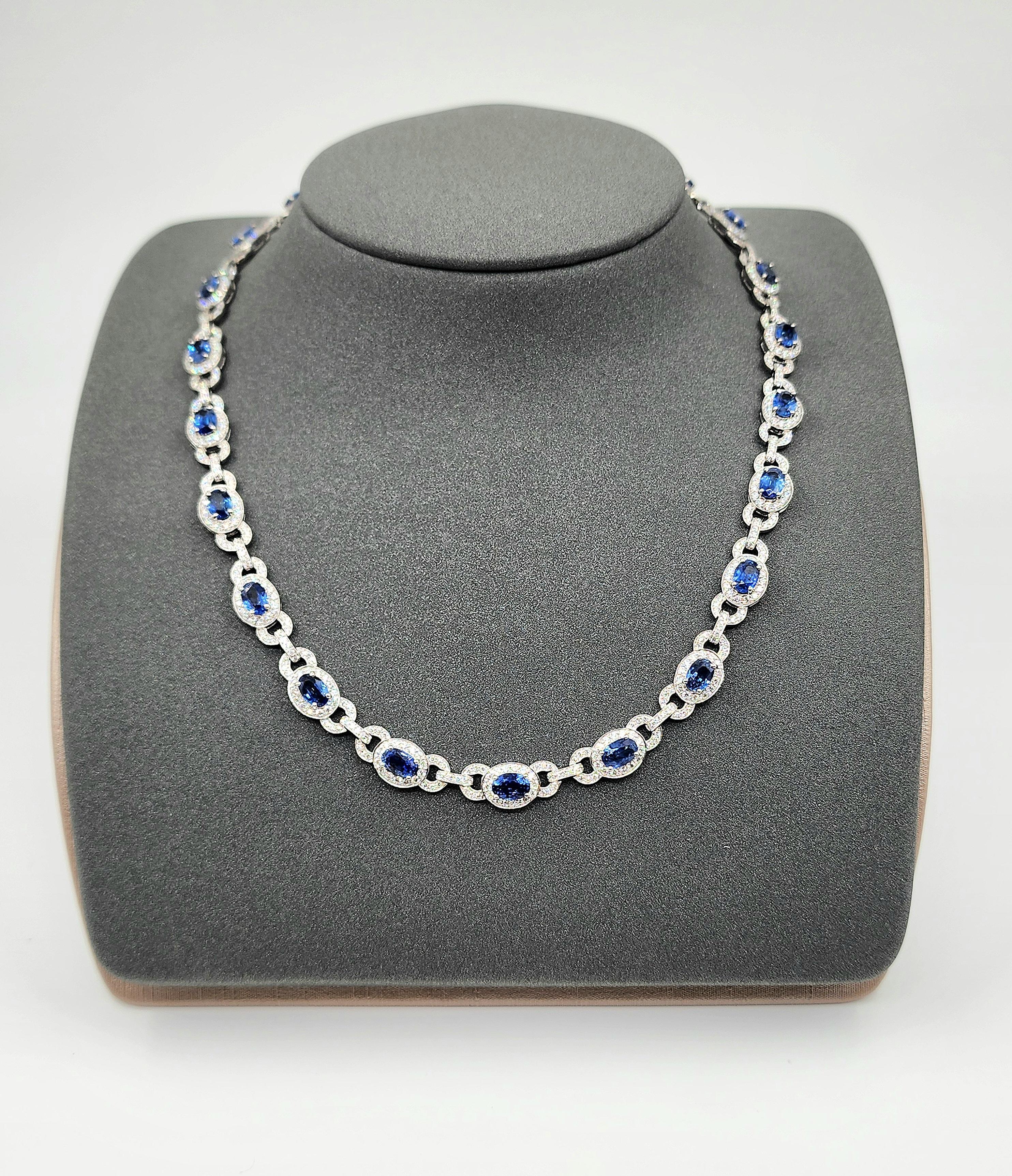 This exquisite necklace features 13.20 carats of 23 oval-cut blue sapphires. Accentuated by 5.15 carats of 737 round-cut white diamonds, each diamond is F/G in color and VS1/VS2 in clarity. Crafted in platinum, the necklace measures 16 inches in