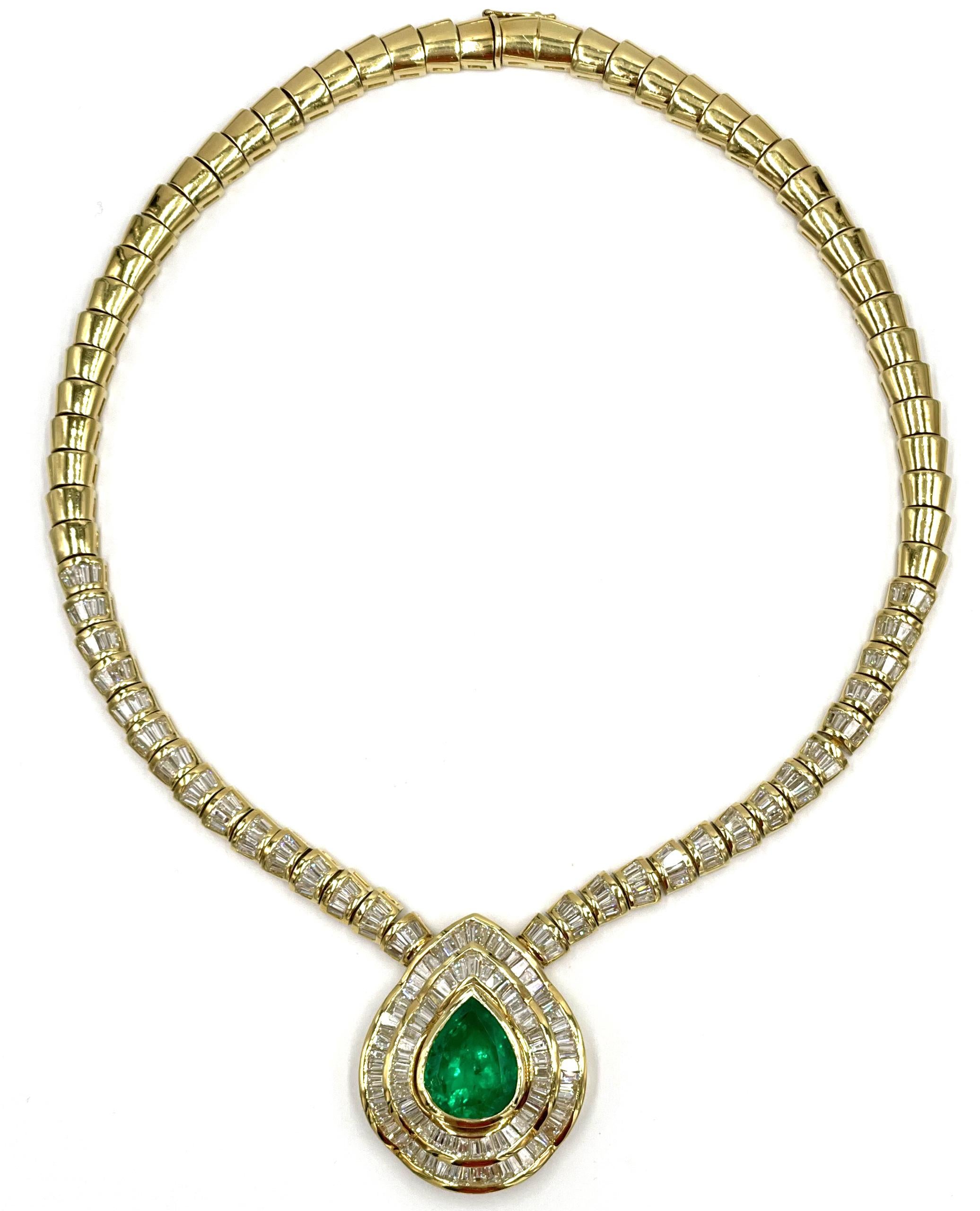Exquisite red carpet 18K yellow gold necklace made circa 1985 features one GIA certified pear shape Colombian emerald weighing 18.44 carats and 217 baguette diamonds weighing 19.06 carats (H color, VS clarity).

-Length: 17 inches 
-Total weight: