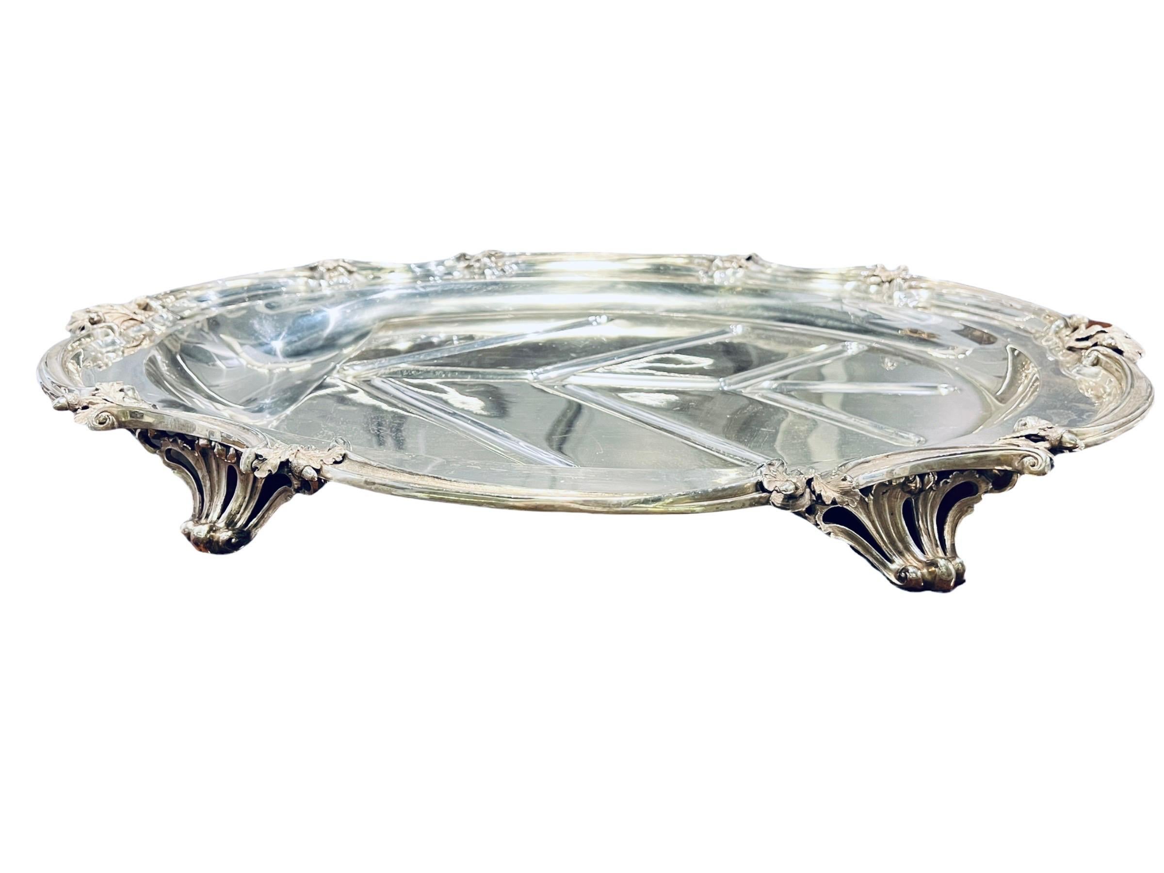 1845 English (London) Victorian silver meat dish platter by Benjamin Smith III. The piece is marked on the base. The platter is composed by pierced shell feet, the boldly scrolled border with oak sprays at the angles, crested and leaves.
   