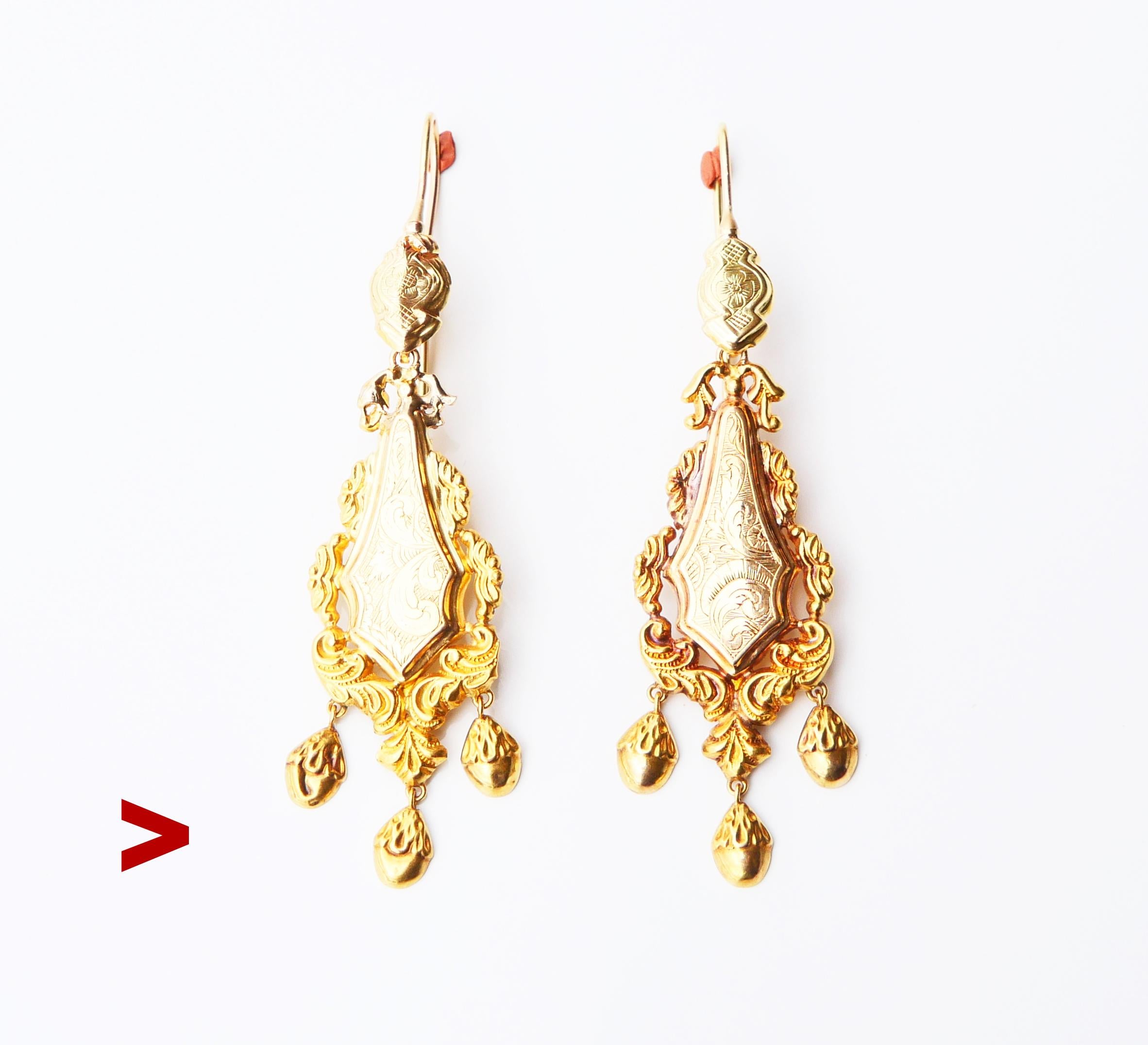 A pair of antique 18K Yellow Gold earrings with drop-shaped pendants and delicate hand-engraved floral ornaments.

Freely suspended dangles are hollow inside.

Swedish hallmarks on both marked 18K Gold.

Maker's marks unknown to me /worn, city of