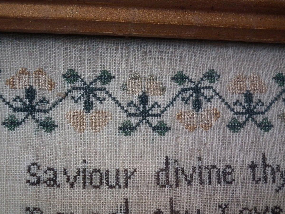 1845 Sampler by Ann Johnson. The sampler is worked in silk on linen ground, in cross stitch throughout. Meandering floral border. Colors black, cream, green, brown and blue. Verse reads 'Saviour divine thy sacred spirit send> Reveal thy Love and