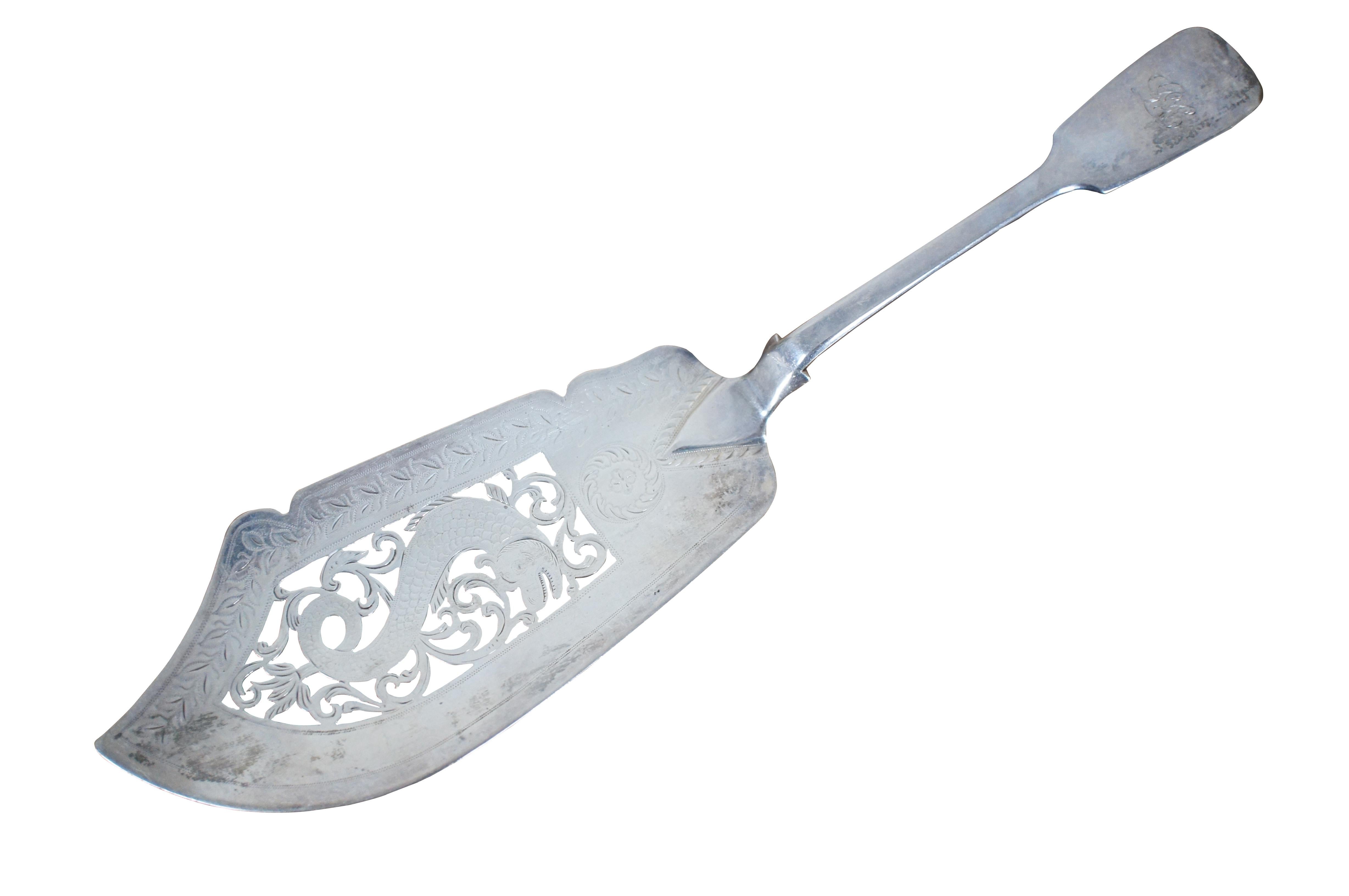 Antique English Victorian sterling silver fish / cake server featuring a tipped handle, etched leaf motif, and pierced foliate and dolphin / Fish Design; made in 1846 by Joseph II & Albert Savory of London. Handle monogrammed with the initials