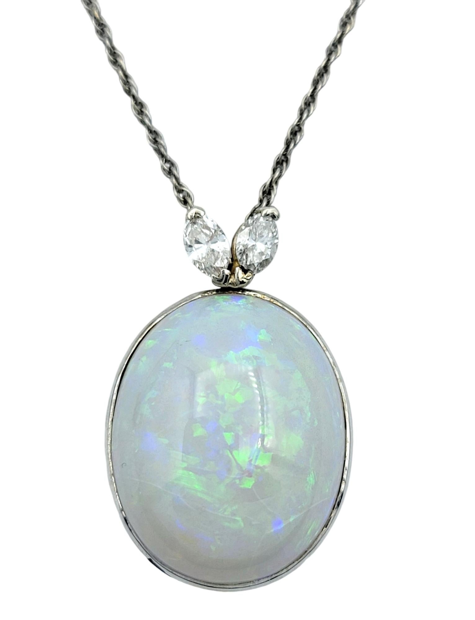 Indulge in the ethereal beauty of this stunning necklace, featuring an impressive 18.46 carat white opal that serves as the captivating centerpiece. The opal exhibits a kaleidoscope of shimmering hues that dance with every movement, making this
