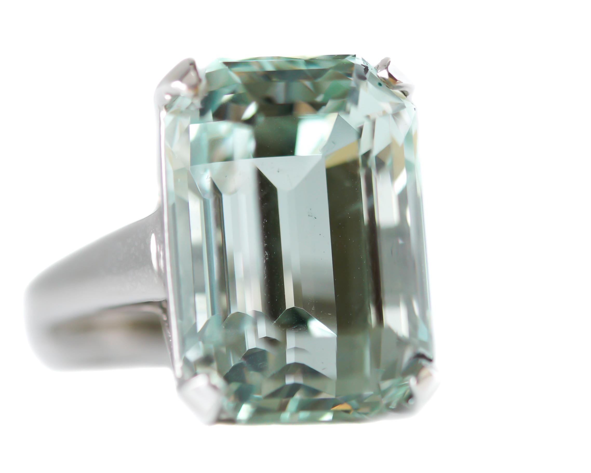 Stunning Aquamarine Ring crafted in 14 karat White Gold

Features: 
18.48 carat Emerald cut Aquamarine
Aquamarine is Light Sea Foam Green in Color
14 karat White Gold Cathedral Setting, Art Deco-Inspired Design Setting
Ornate, Open Gallery and