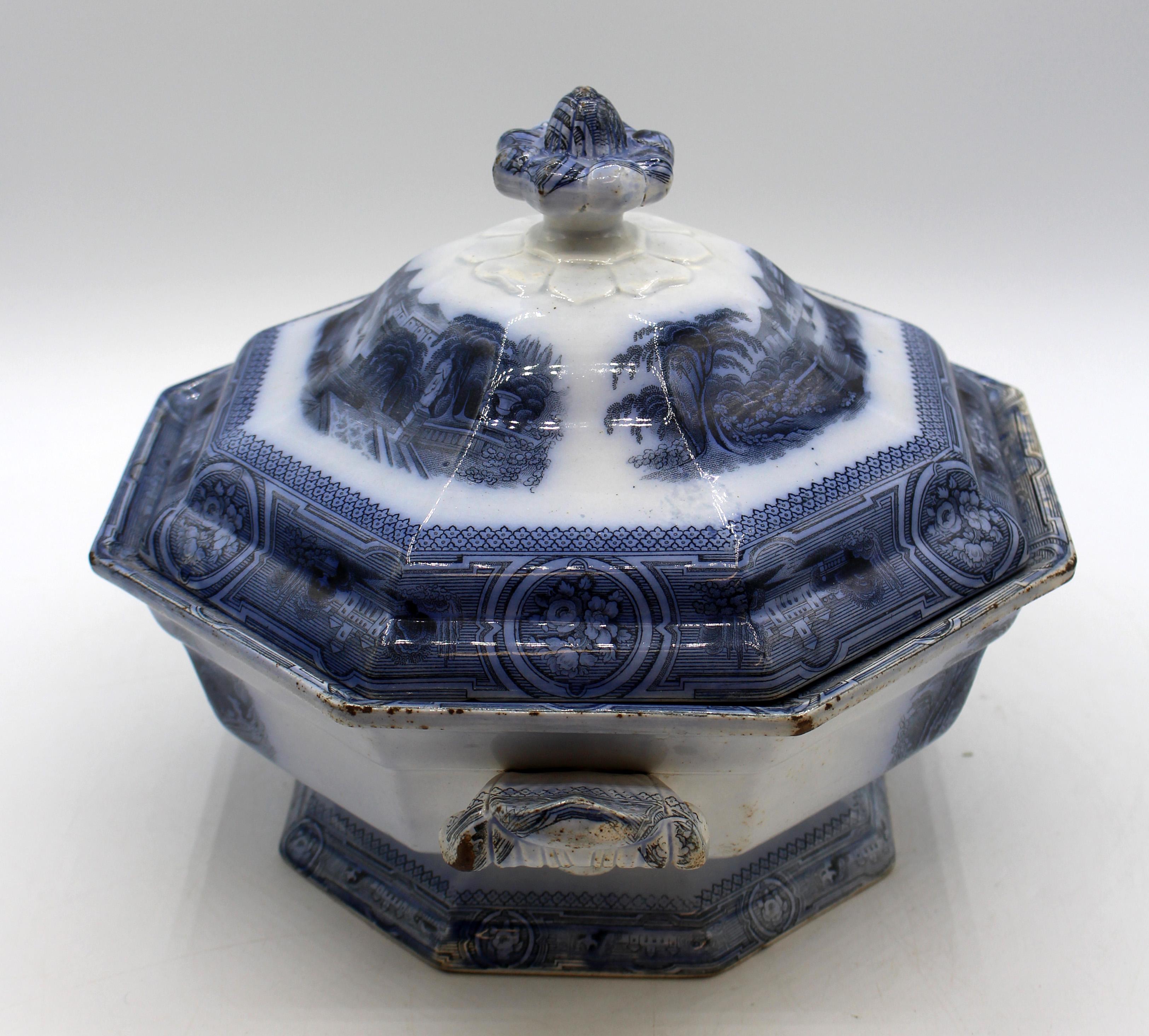 1849 English Staffordshire Covered Tureen. Octagonal form with original cover - each with registry mark for April 2, 1849. Romantic scene. Family descent on inside of cover. Old inner cover edge chip. Minor rubs & 2 interior kiln pops. Charmingly,