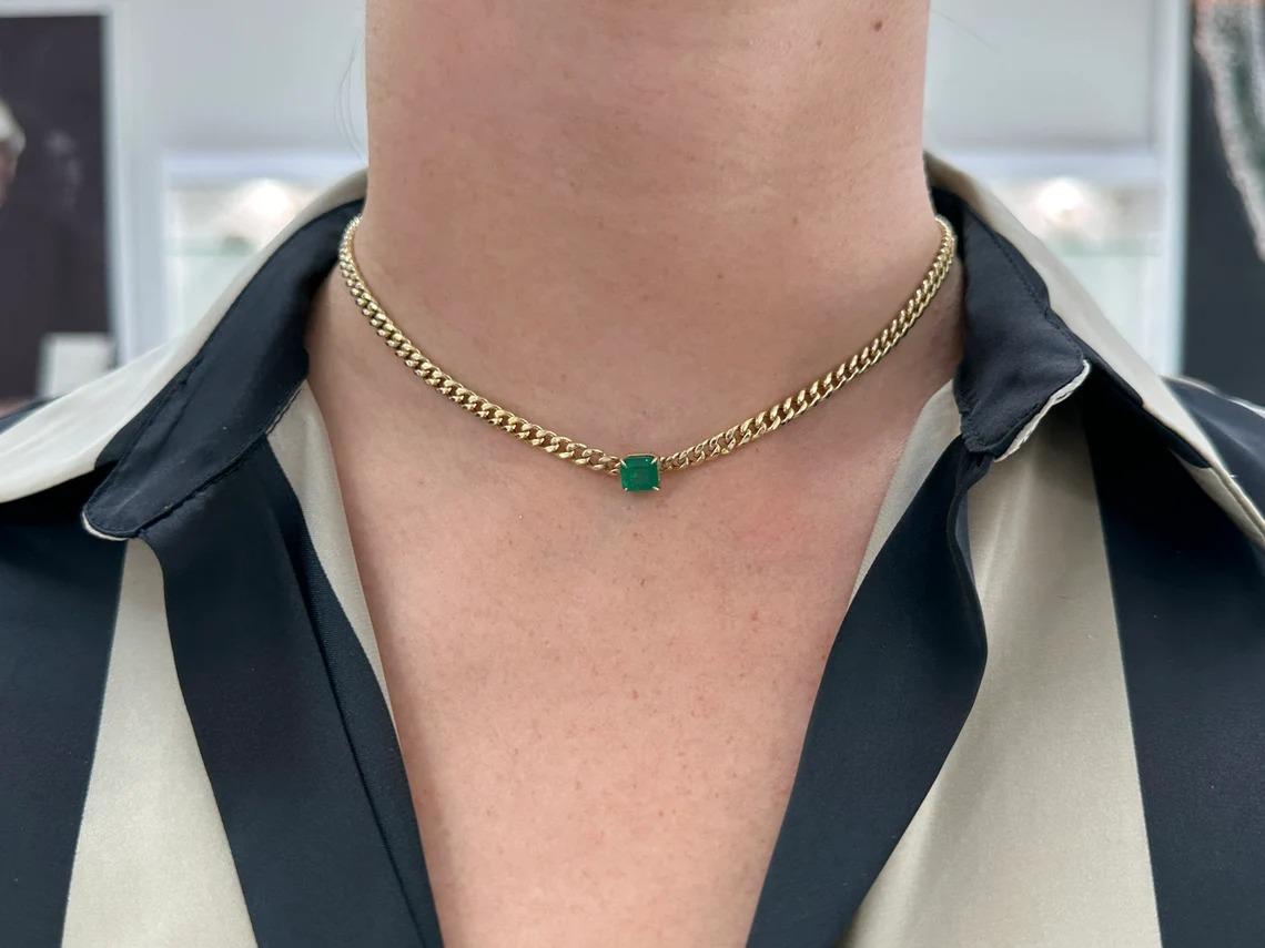 A remarkable emerald necklace in gold. This extravagant piece features a stunning natural Asscher cut emerald that showcases a rich dark green color and excellent to very good clarity and luster. Set in a secure four-prong claw setting, attached to