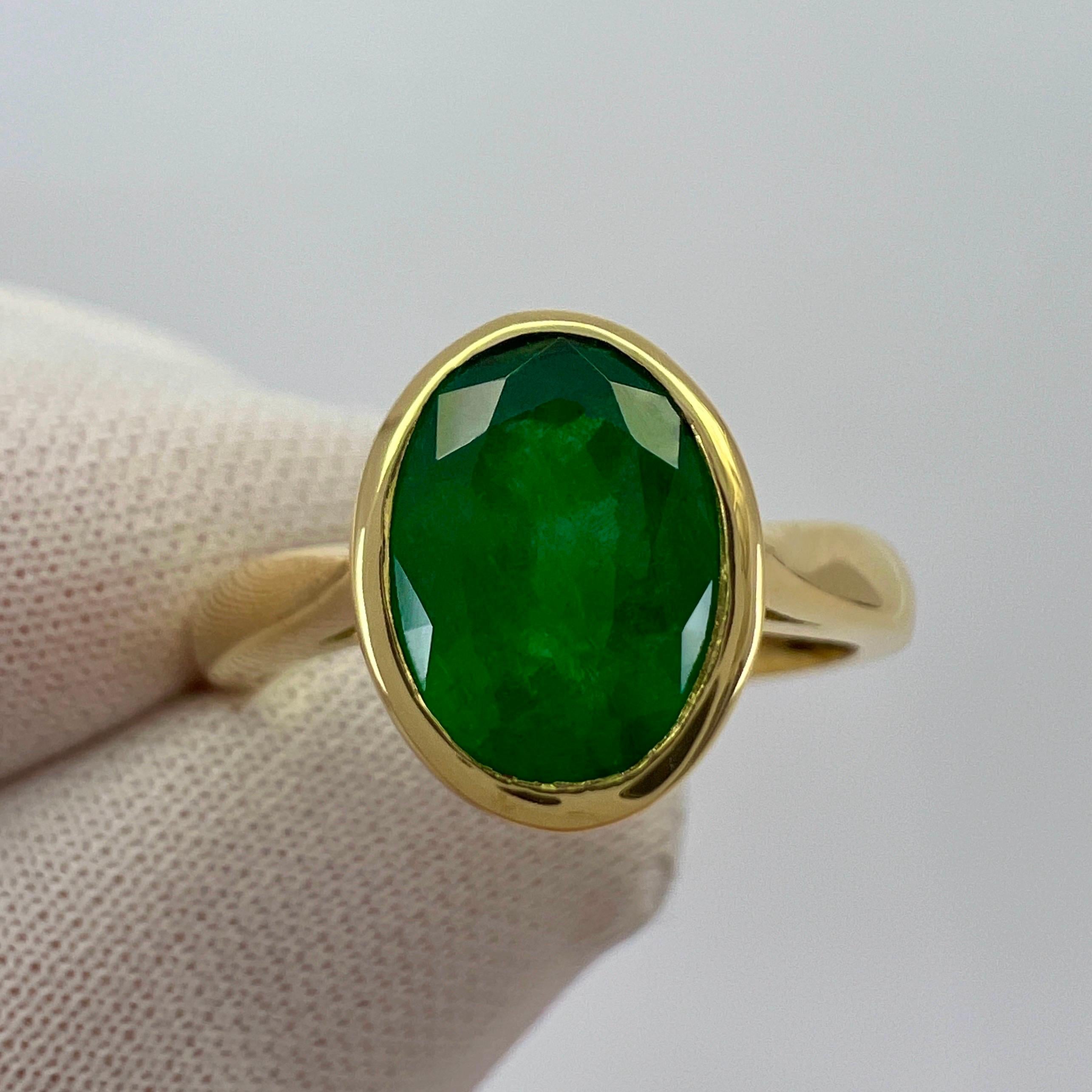 Fine Deep Green Oval Cut Emerald 18k Yellow Solitaire Bezel Rubover Ring.

1.84 Carat emerald with a stunning deep green colour and good clarity with only some small natural inclusions visible. As to be expected with natural emeralds. But a clean