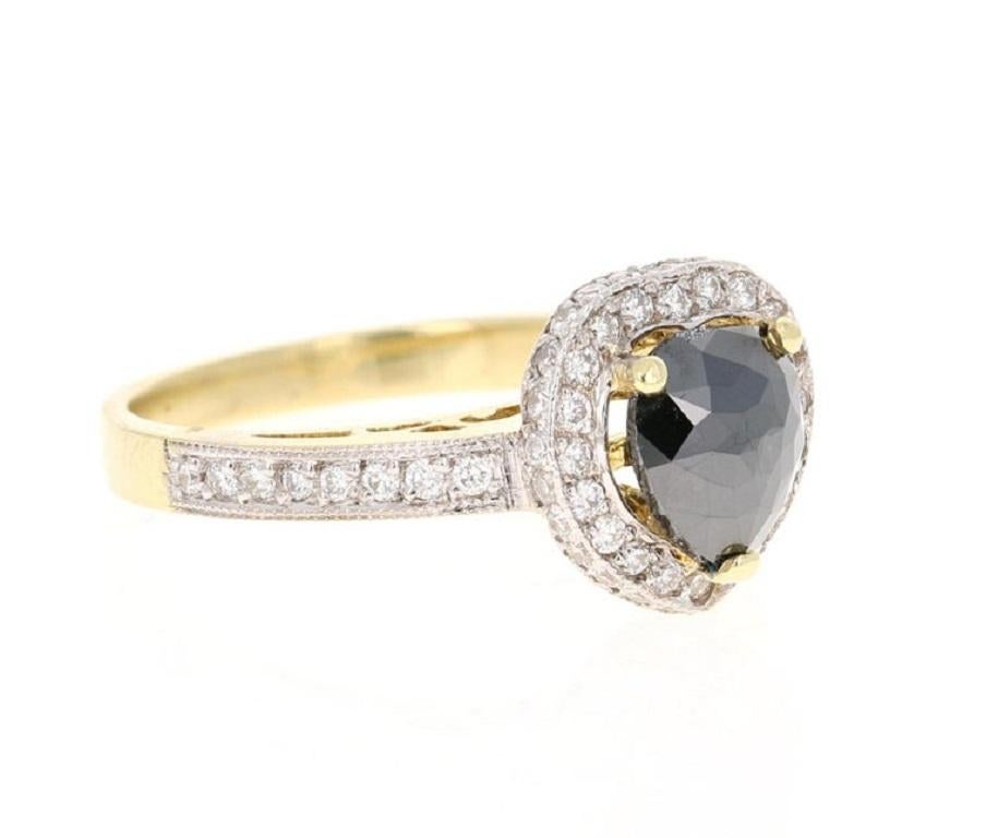The Pear/Heart Cut Black Diamond is 1.28 Carats and is surrounded by 67 Round Cut Diamonds that weigh 0.57 Carats. The total carat weight of the ring is 1.85 Carats. 

It is beautifully set in 14 Karat Yellow Gold and is approximately 5.9 grams.