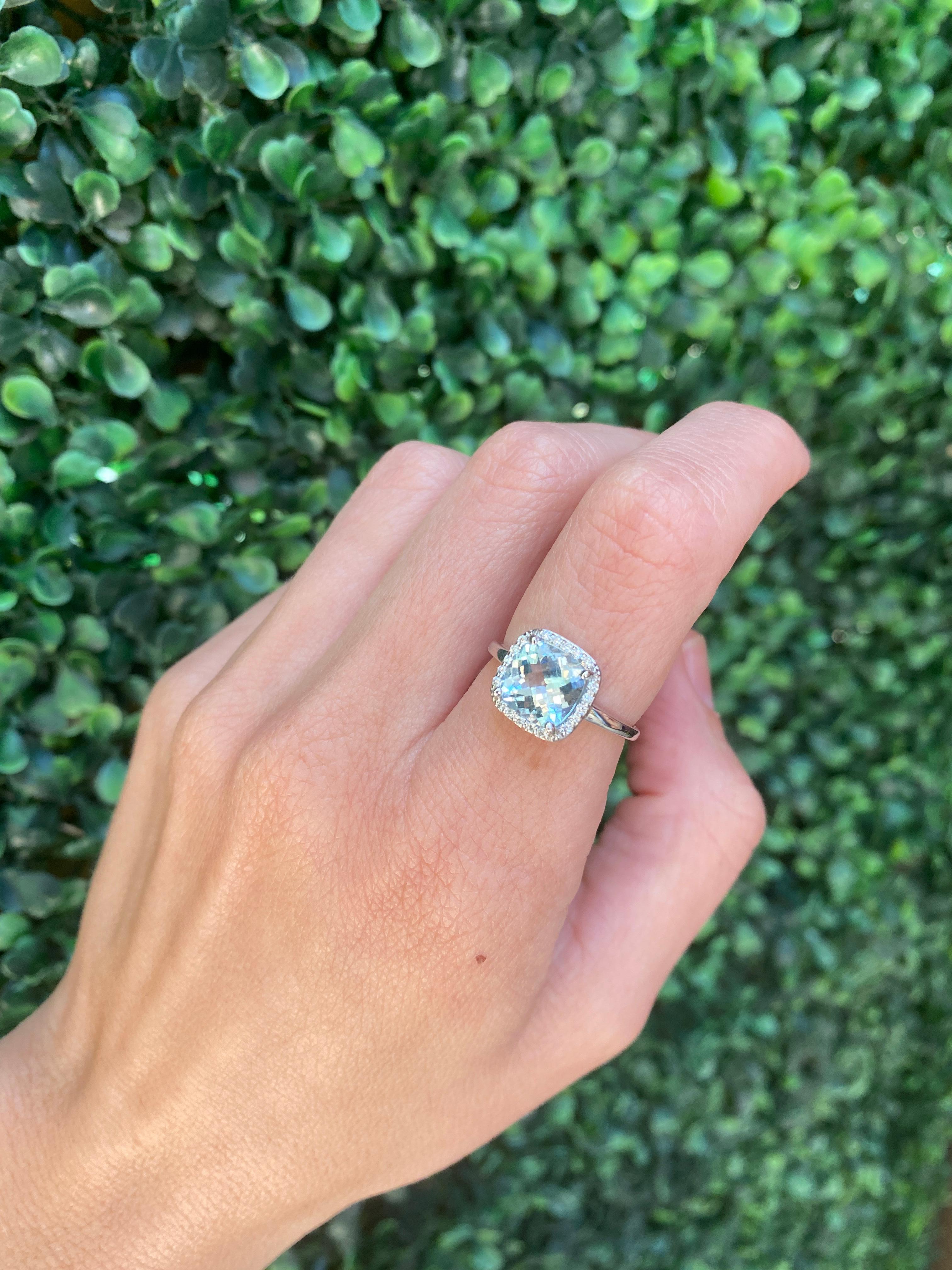 This beautiful ring features a 1.85 carat aquamarine accented by a diamond halo with a total carat weight of 0.13 carats. This ring is a size 6.75 but can be resized upon request. 
Measurements: Aquamarine measures approximately 8.20mm x 8.20mm