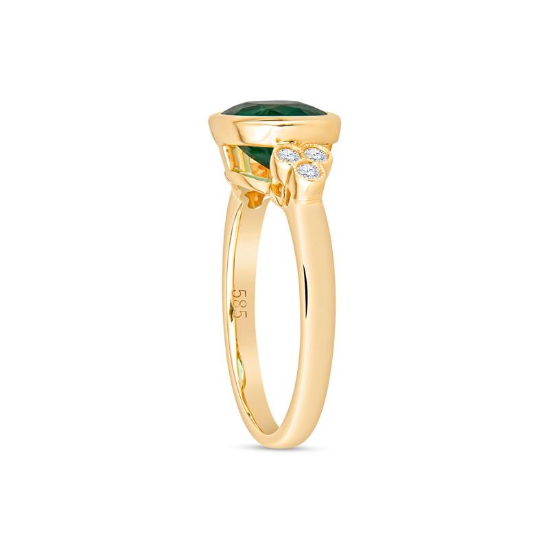 This exquisite ring features a vibrant 1.85 carat oval emerald, beautifully bezel set in luxurious 14K yellow gold. Adorned with six brilliant round diamonds totaling 0.10 carat total weight, this contemporary piece is perfect for adding a touch of