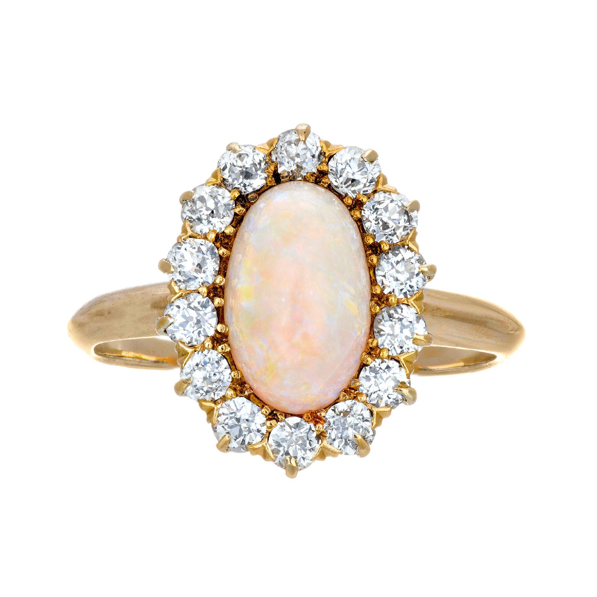 1.85cts Oval opal and diamond halo engagement ring.  circa 1900's with orange blue and green flash as well as some red, in a 14k yellow gold setting. 

1 fine oval natural orange blue green Opal, approx. total weight 1.85cts, 9.8 x 4 x 3.8mm
14 old