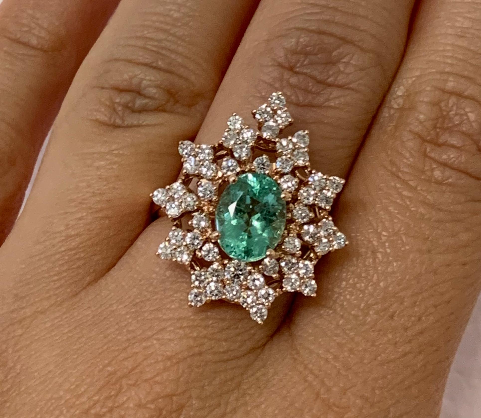 Material: 14k Rose Gold 

Center Stone Details: 1.85 Carat Oval Shaped Paraiba Tourmaline -Measuring 8.8 x 6.9 mm
Diamond Details: 55 Brilliant Round White Diamonds at Approximately 1.2 Carats - Clarity: SI / Color: H-I
Ring Size: 6.75.