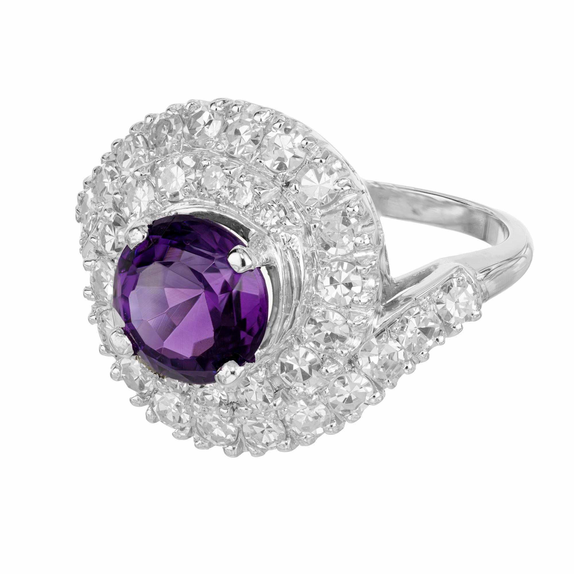 Wonderful swirl design 1950's amethyst and diamond cocktail ring. The center piece of this mid-century design is a round purple amethyst. Mounted in a platinum setting, this gemstone is haloed with two rows of single cut diamonds in a swirl design.