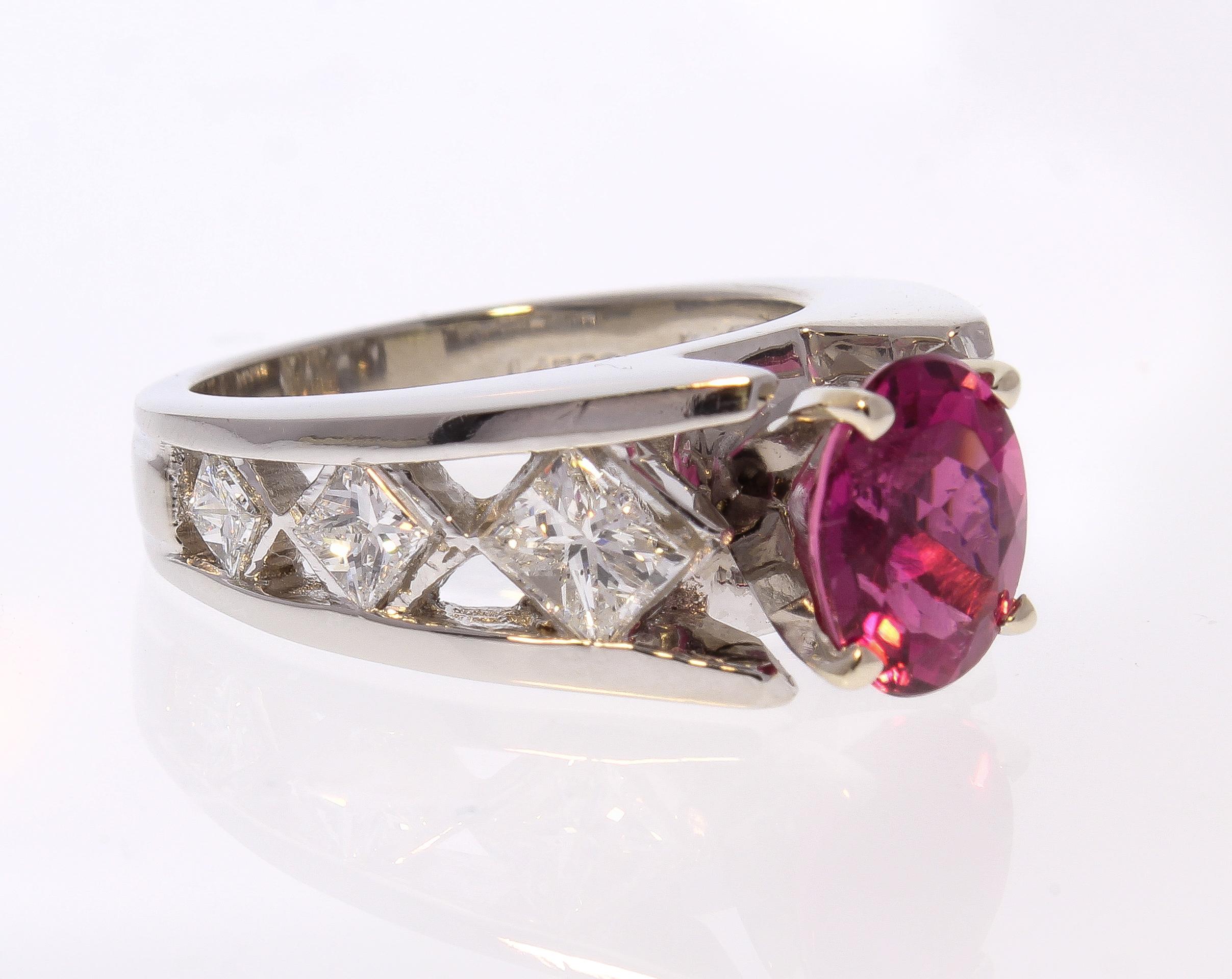 This is a statement rubellite tourmaline ring is perfect for those who adore this unique semi-precious colored stone, crafted in brightly polished platinum. The modern design of this gemstone and diamond ring showcases a gorgeous 1.85 carat