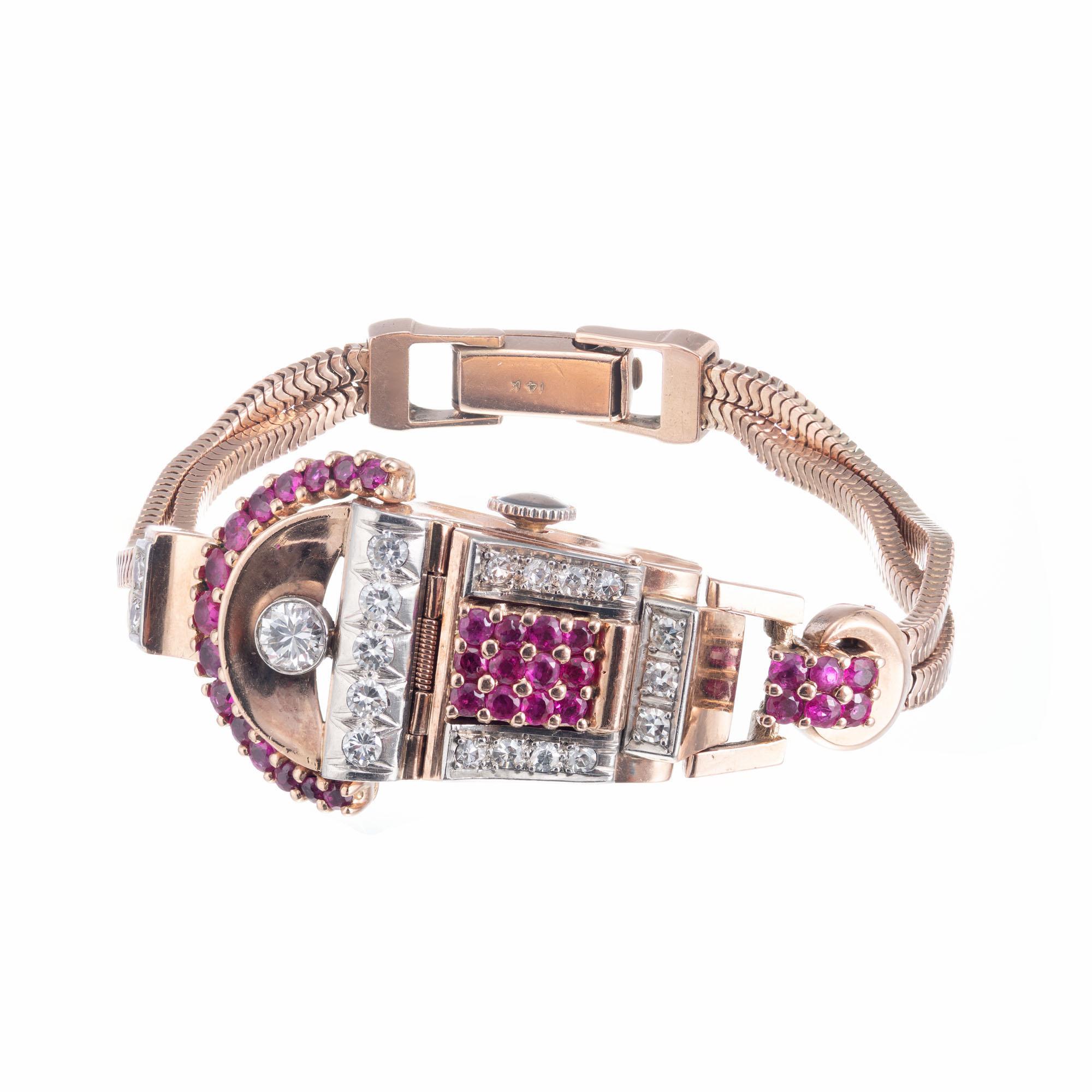 1940's Vintage Retro Asymmetrical covered wristwatch in 14k rose gold with a double snake chain band in Rose Gold. 19 round diamonds with 33 natural round accent rubies. 6 3/8 Inches

33 natural rubies, approx. 1.25 cts
19 diamonds H-I, VS, approx.