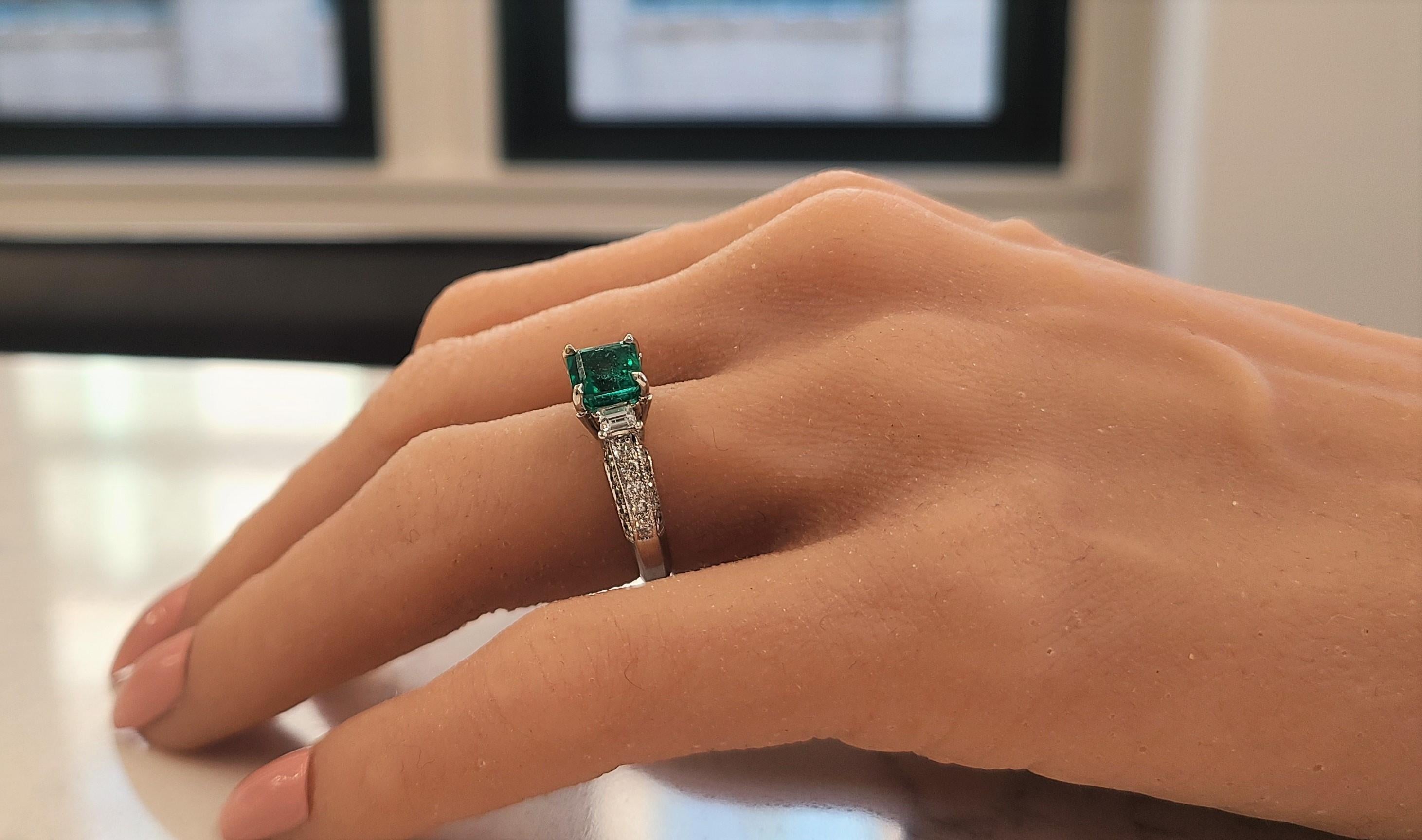 Celebrate your next anniversary or engagement moment with this vintage style, brightly polished 14k white gold emerald and diamond ring. A fine quality 1.85 carat square emerald cut emerald with measurements of 7.50mmx7.50mm sits in the center. The