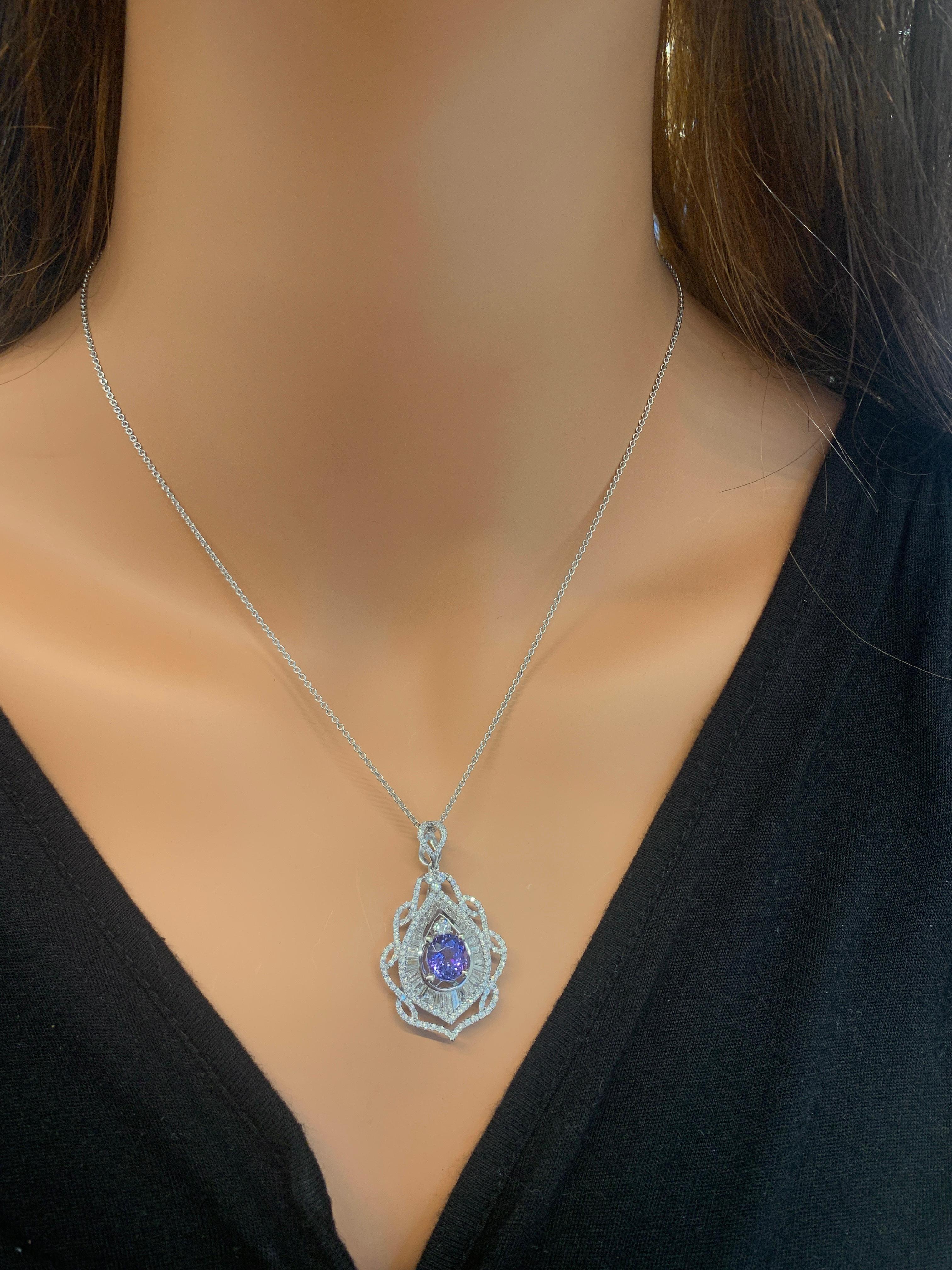 Tanzanite is the birthstone for December, making this gorgeous, brightly polished 18k white gold drop pendant an unforgettable gift to give. A round cut 6.8X7.4MM tanzanite sits nestled in the center displaying an intense bluish-purple color. A