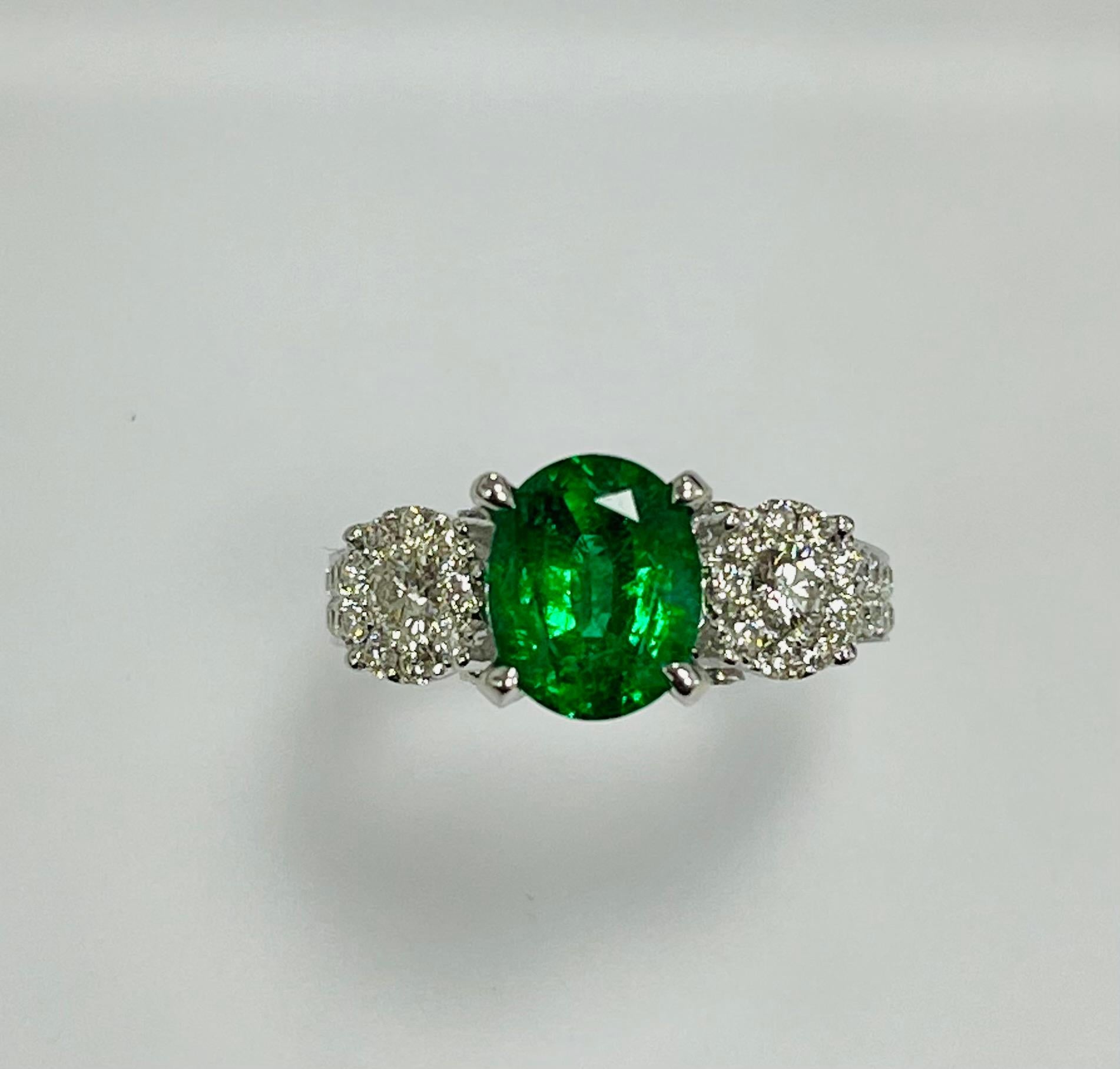 1.85 Carat Zambian oval cut emerald set in 18k white ring with  1.0 ct approximaitely  diamonds around , on the sides and half way on the shank.