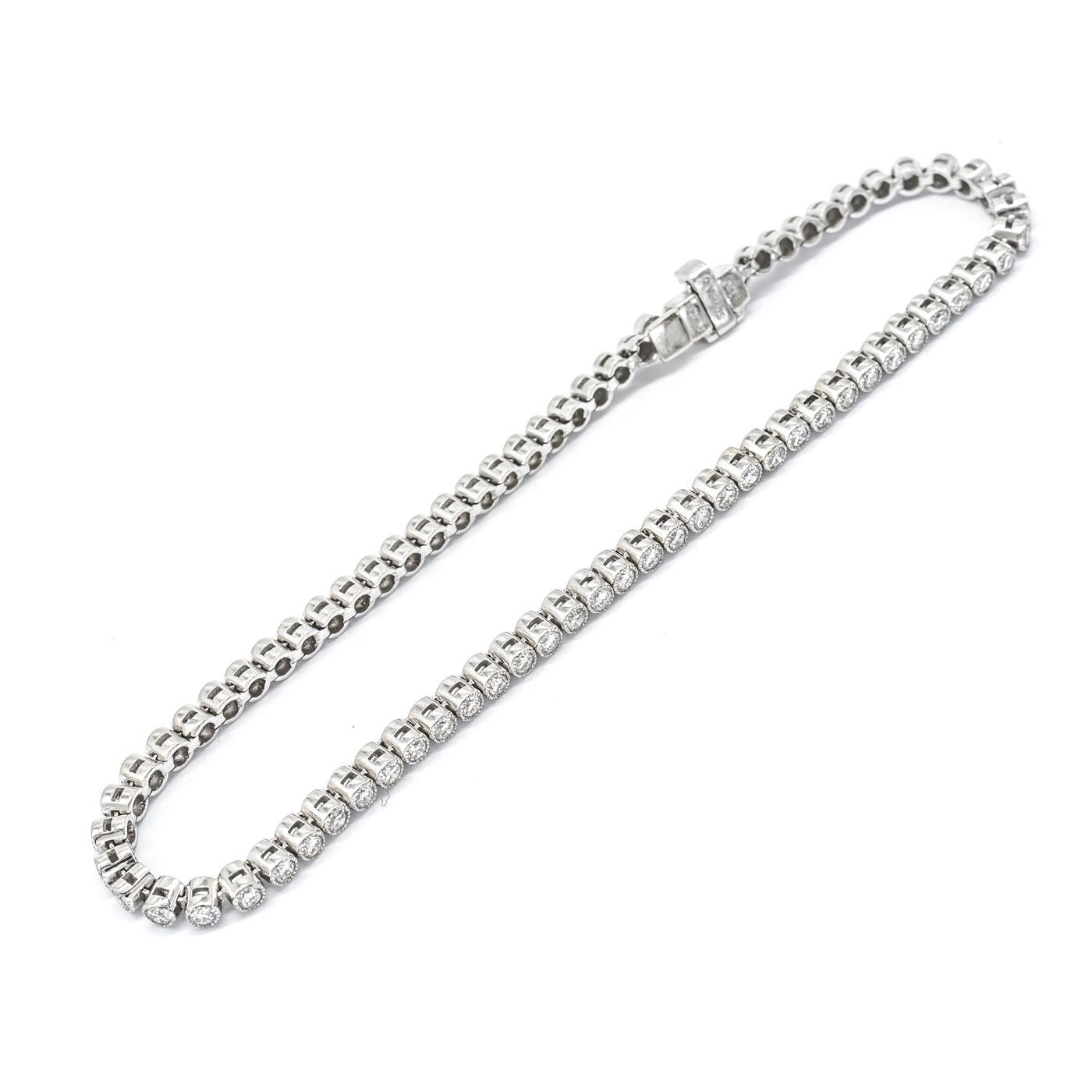 Diamond line bracelet, set with round brilliant-cut diamonds in millegrain edged rub over settings. Mounted in platinum. Estimated total diamond weight 1.85ct. 