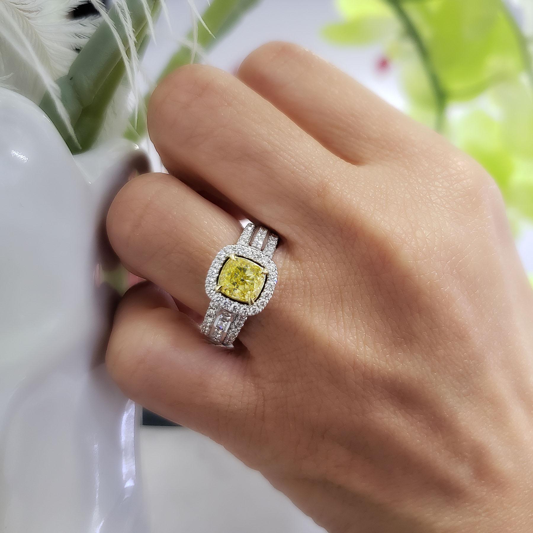 What a wonderful ring made only by King of Jewelry. It features a 0.80 Ct. Fancy Yellow Cushion cut diamond as its center stone with a clarity of VS2. Round Cut Diamonds are Pave set flowing down the shank and princess cut diamonds set as channel