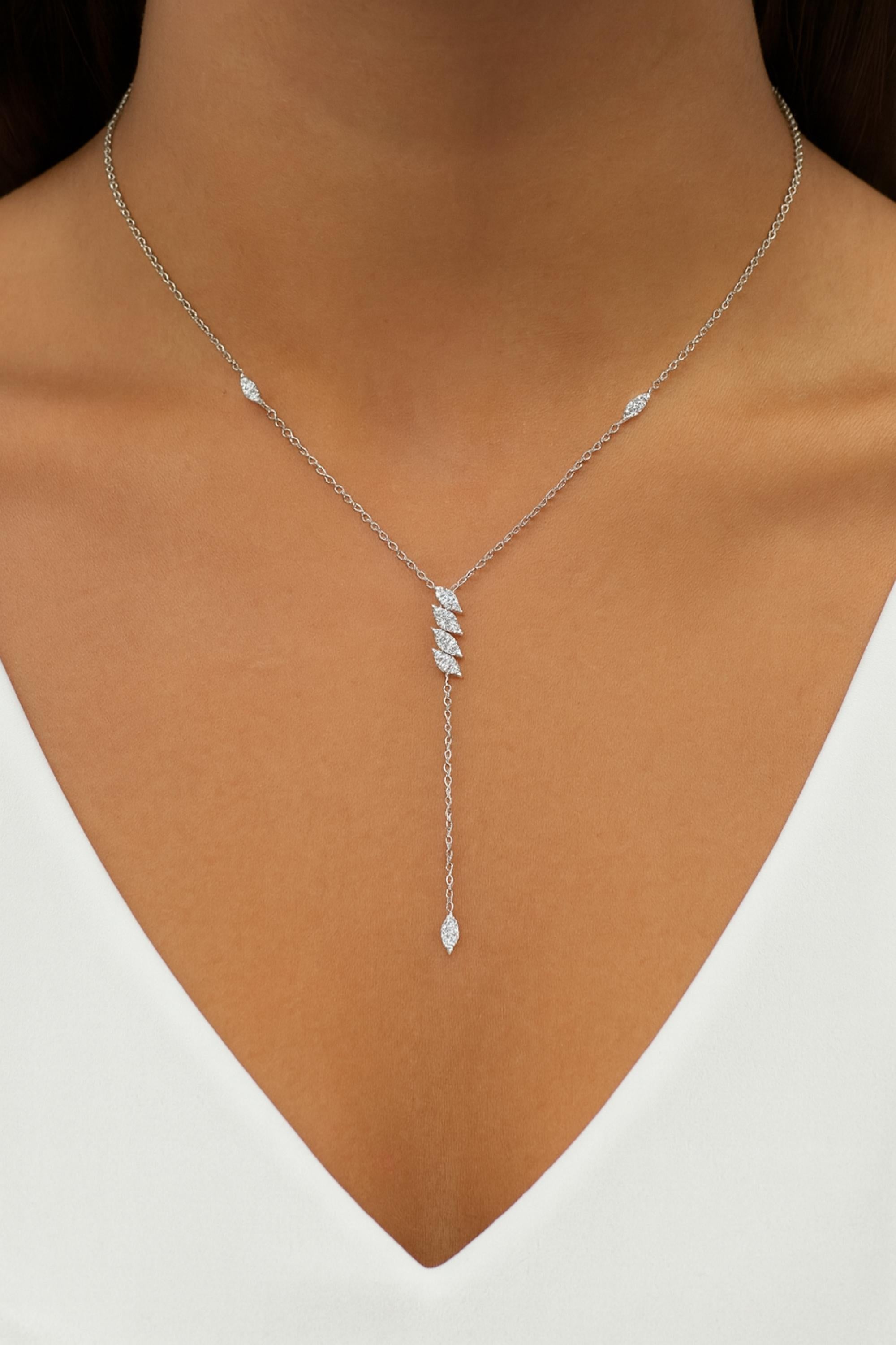 This Marquise Diamond Lariat Necklace is a versatile piece that can be worn for various occasions, adding a touch of glamour and sophistication to any ensemble. Whether dressed up for a formal event or paired with a casual outfit, this necklace is