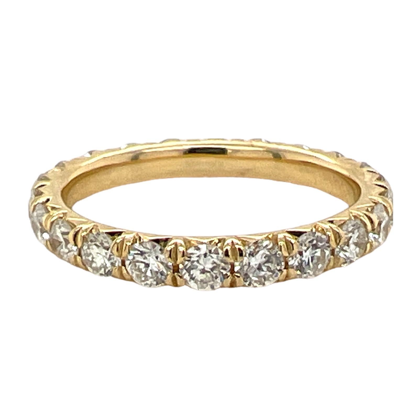 Diamond eternity band fashioned in 18 karat yellow gold . The band features round brilliant cut diamonds weighing 1.85 CTW and graded G-H color and SI clarity. The band is size 7 and measures 2.7 mm in width. 

